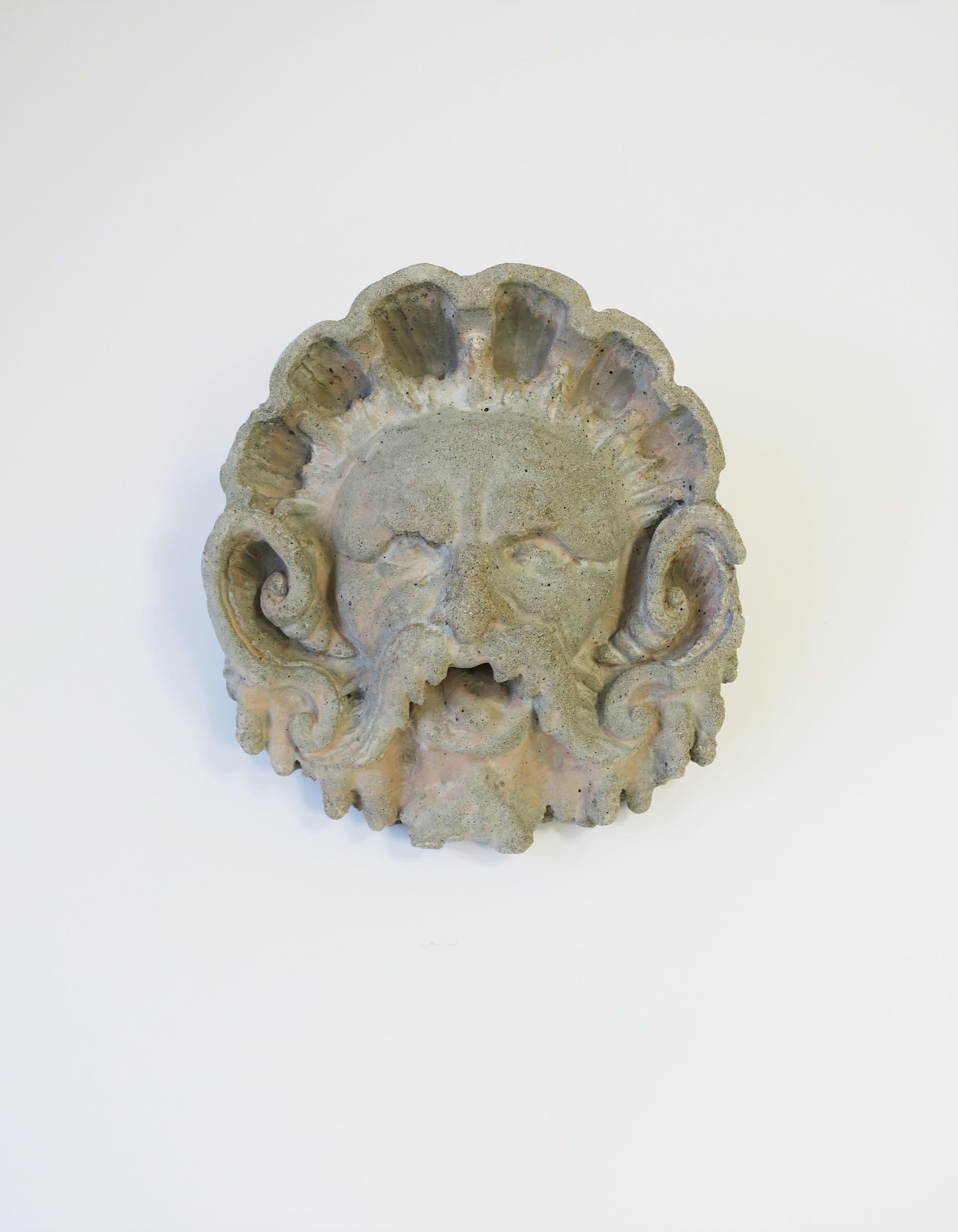 A substantial 20th century garden god face or 'facemask' fountain sculpture head element. Piece is made of concrete and iron with round hole at mouth open from front to back for water flow. Close-up of hole, front and back, see images 6, 7 and 11.