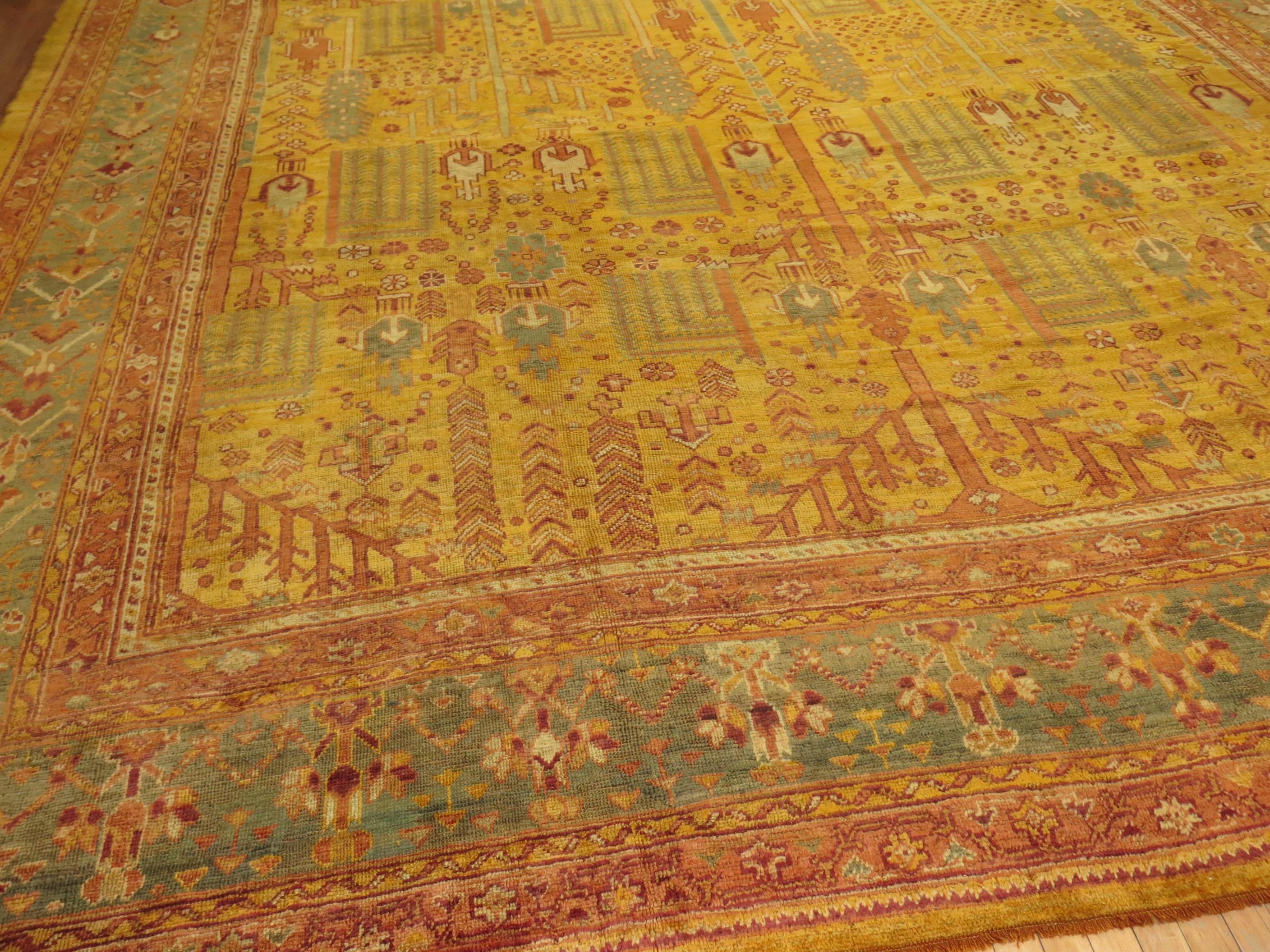 Stunning oversize antique Turkish Oushak rug with a weeping all-over willow tree garden of paradise design with golden saffron dominant field.
With a seldom encountered energetic verdancy, this absolutely charming, folkloric antique oversize Turkish