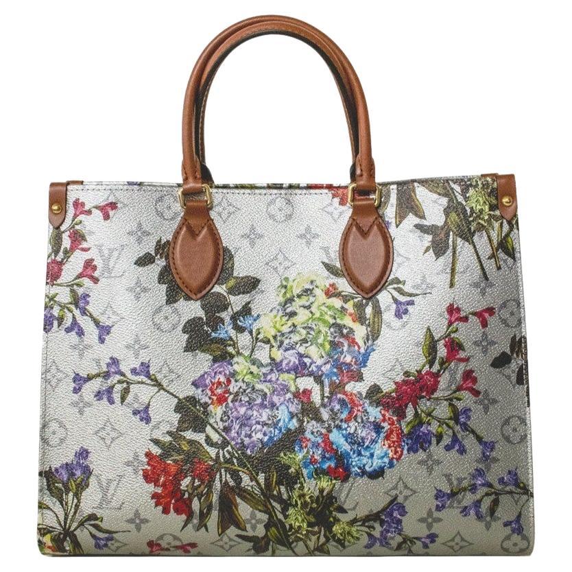 Featuring a feminine floral design and metallic-silver coated canvas, the OnTheGo MM tote by Nicolas Ghesquière adds a touch of elegance to any outfit. The bold pattern is complemented by a subtle Monogram motif in the background, and the microfiber