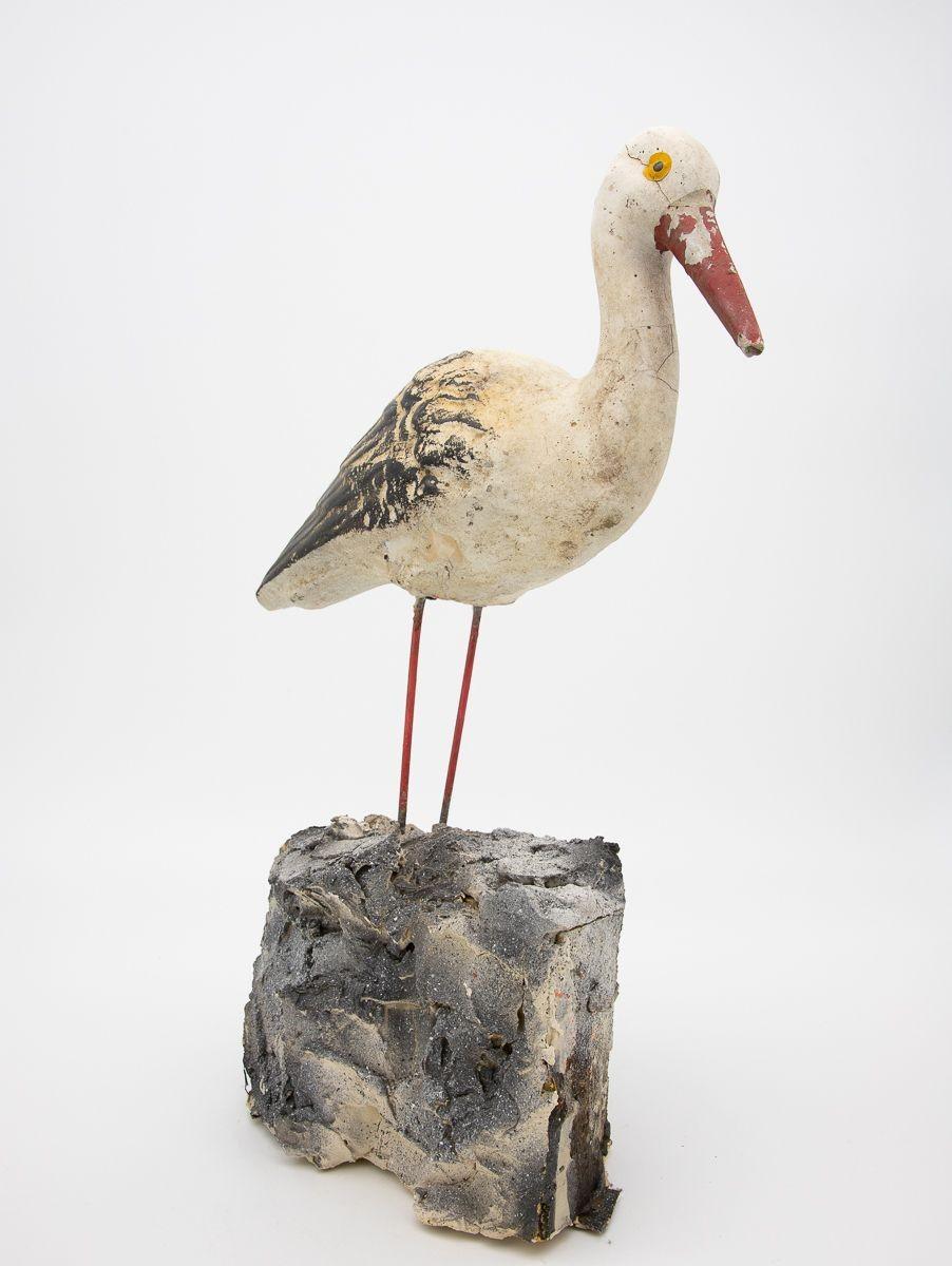 20th Century garden ornament of a cast stone seagull on a wood base. The seagull retains much of its original paint.