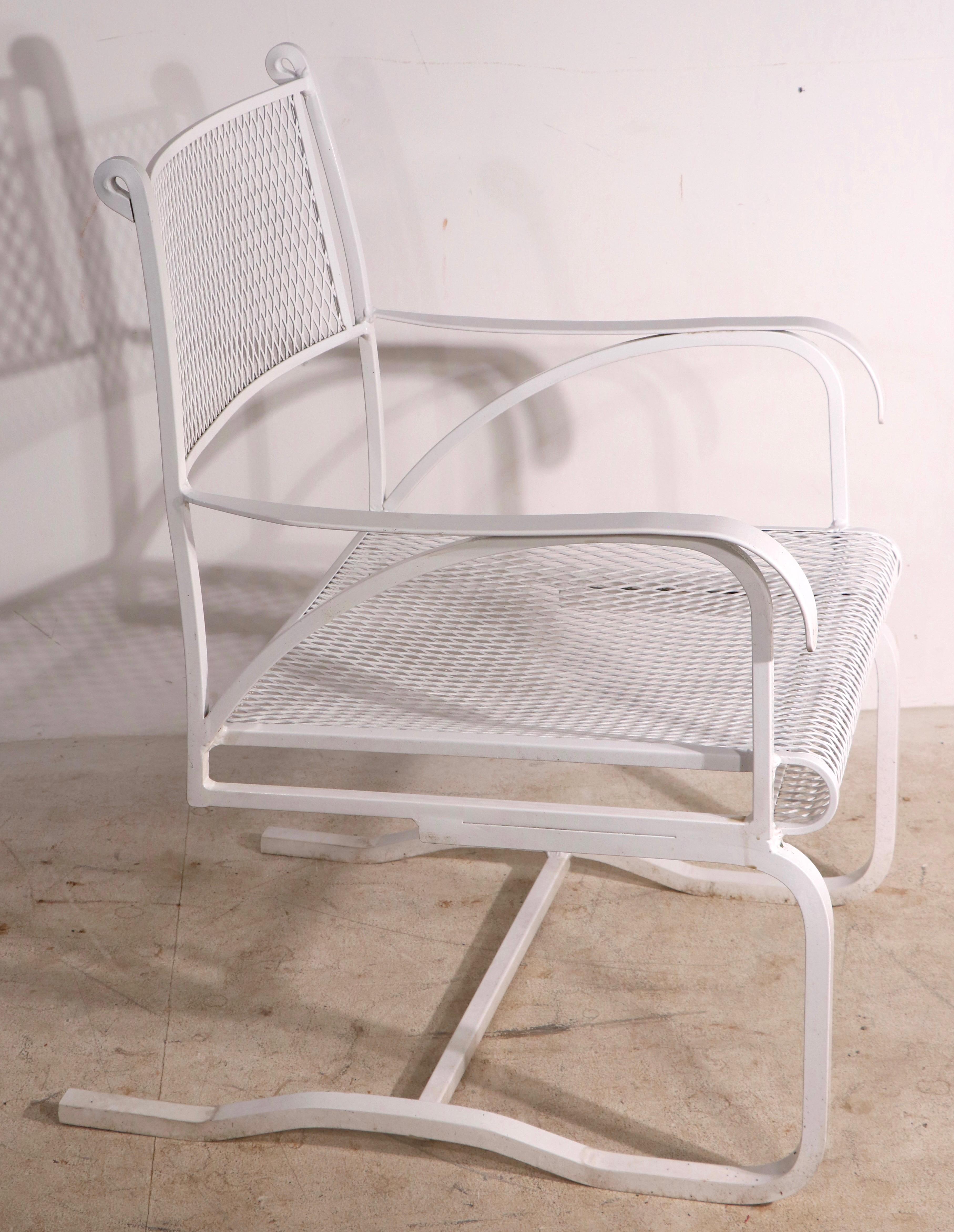 Chic architectural cantilevered dining height arm chair, having a squared stock metal frame, and a metal mesh seat and back. Manufacture attributed to Woodard, this example is unsigned. Usable as is, we also offer custom powder coating if you prefer