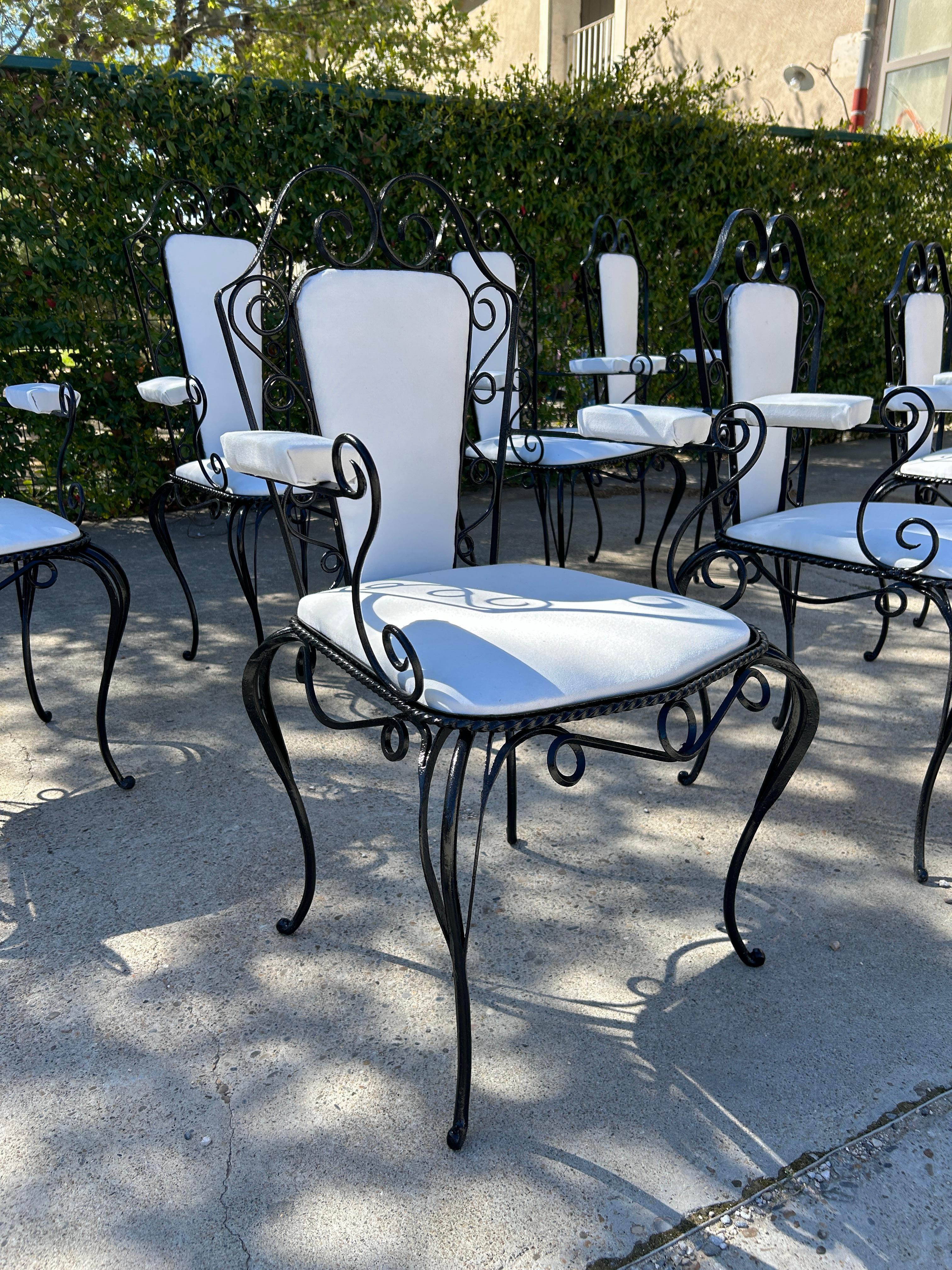Garden set attributed to René Drouet in wrought iron decorated with curves and volutes. French work 1940 including : 

4 men armchairs: Height: 107 x Width: 55 x Depth: 54 cm 
Seat height: 46 cm 
4 women armchairs: Height 95 x Width 55 x Depth 54 cm