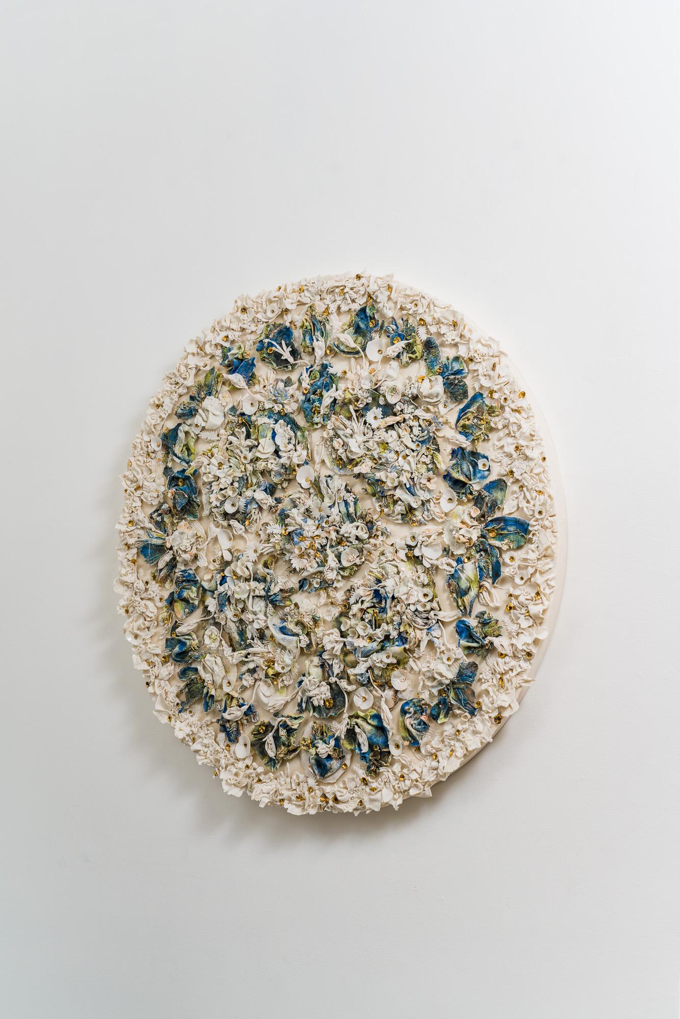 Mindy Horn’s ceramic “Garden Tondo” revisits elements most often seen in her vessels, which are notable for their imperfections, appearing to have grown and then weathered organically. With her most recent ceramic wall medallion, a multitude of