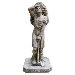 Garden Worker in English Stoneware with Shovel Carrying A Bag of Grapes