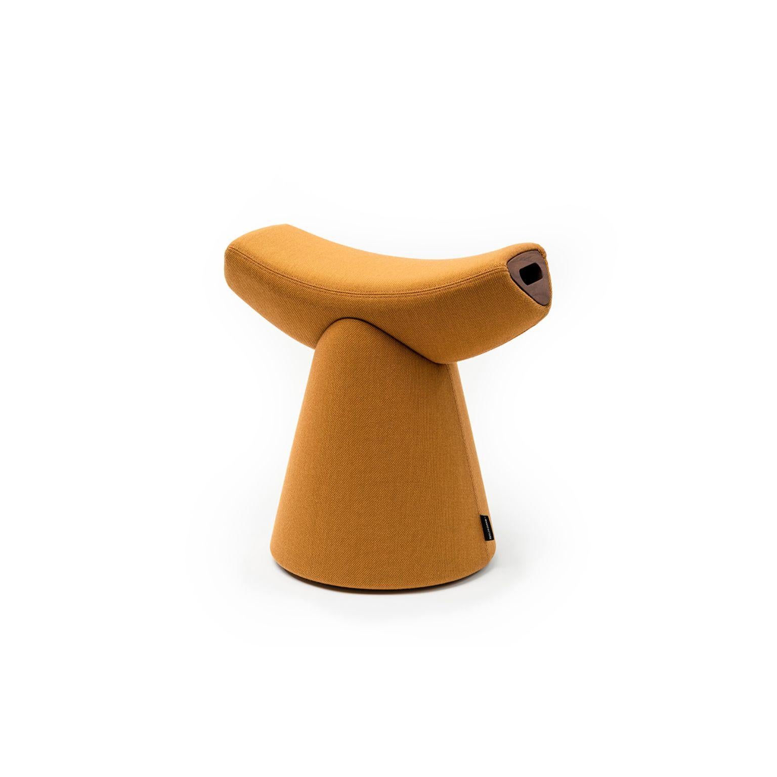 Gardian stool with handle by Patrick Norguet.
Materials: fabric (also available in leather)
 Handle: noce Canaletto solid wood.
Dimensions: W 51.1 x D 34.7 x H 49.8 cm.

For the Gardian stool by designer Patrick Norguet, the concept of seating