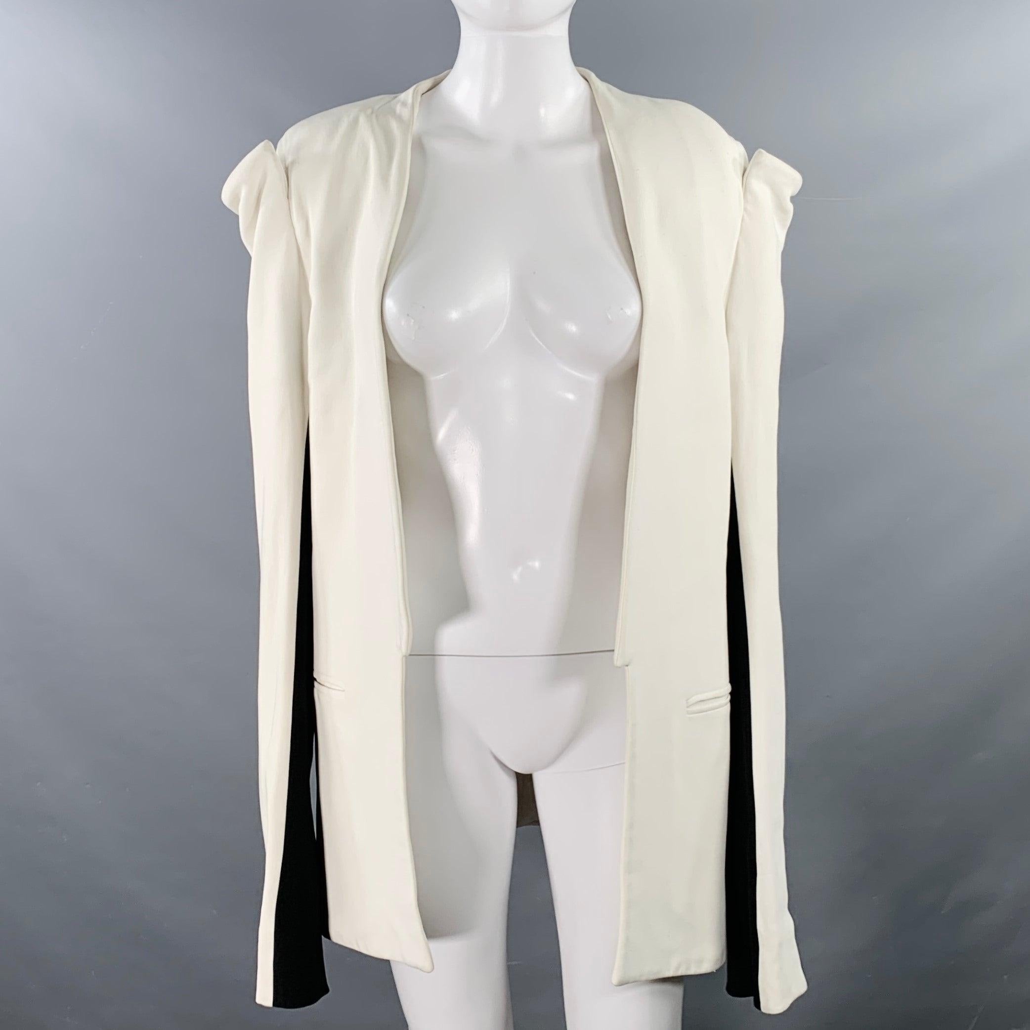 GARETH PUGH SS09 Debut Collection coat in a white and black fabric featuring a elbow cut-out detail, slit pocket, single back vent, and an open front. Good Pre-Owned Condition. Moderate discoloration throughout. Fabric tag removed. As is. 

Marked: 