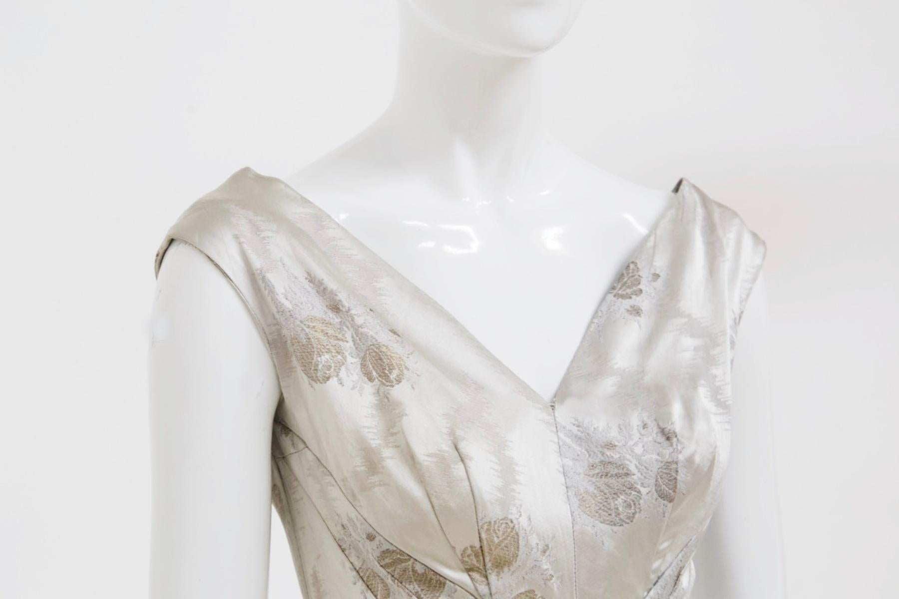 Sumptuous vintage sartorial dress designed in the 1950s, fine Italian craftsmanship.
The dress is made entirely of pearl gray silk satin, very elegant and delicate.
The straps are thin and stop at the shoulder, giving prominence to the chest and its