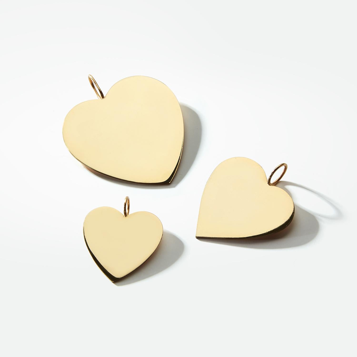 Garland Collection's solid gold heart charms are custom and hand made to order by our master bench jewelers in Los Angeles. Garland's solid gold hearts may be styled in multiple ways -- on a full charm necklace, a single chain or a bracelet. The