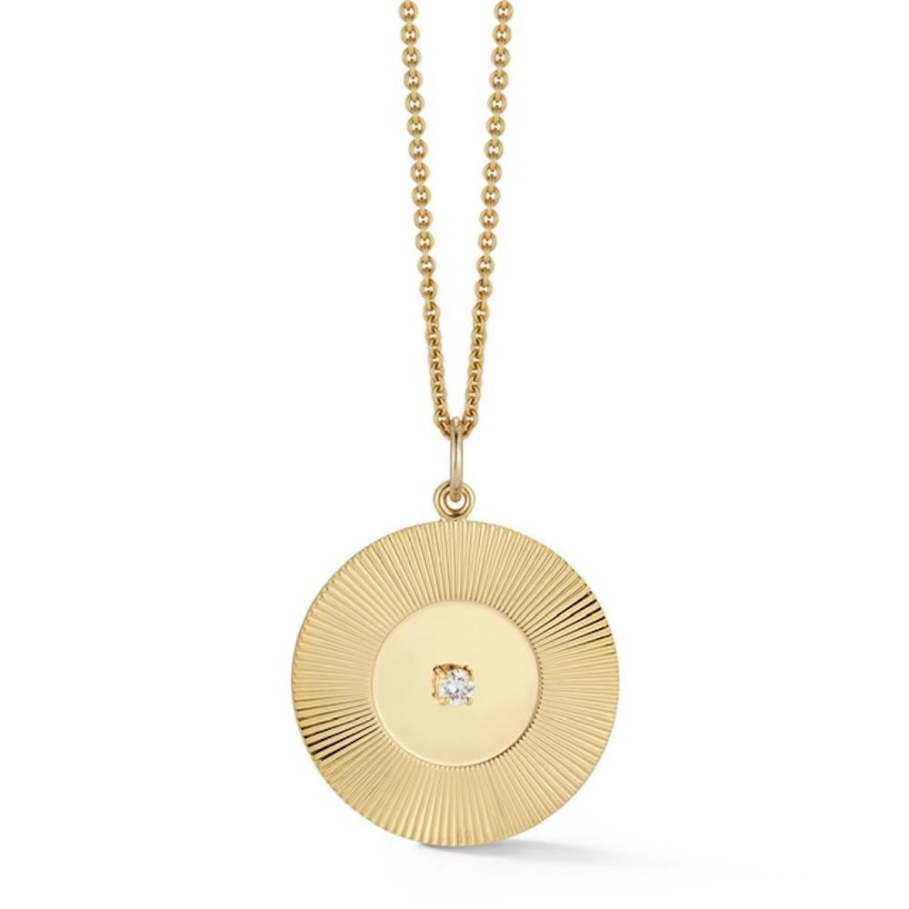 We love these shimmering throwback details for old-school glam. Set with a brilliant diamond on a large engine turned gold disc, these are perfect for adding to a necklace chain or charm bracelet. Each disc is handmade to order in NYC. 

The back