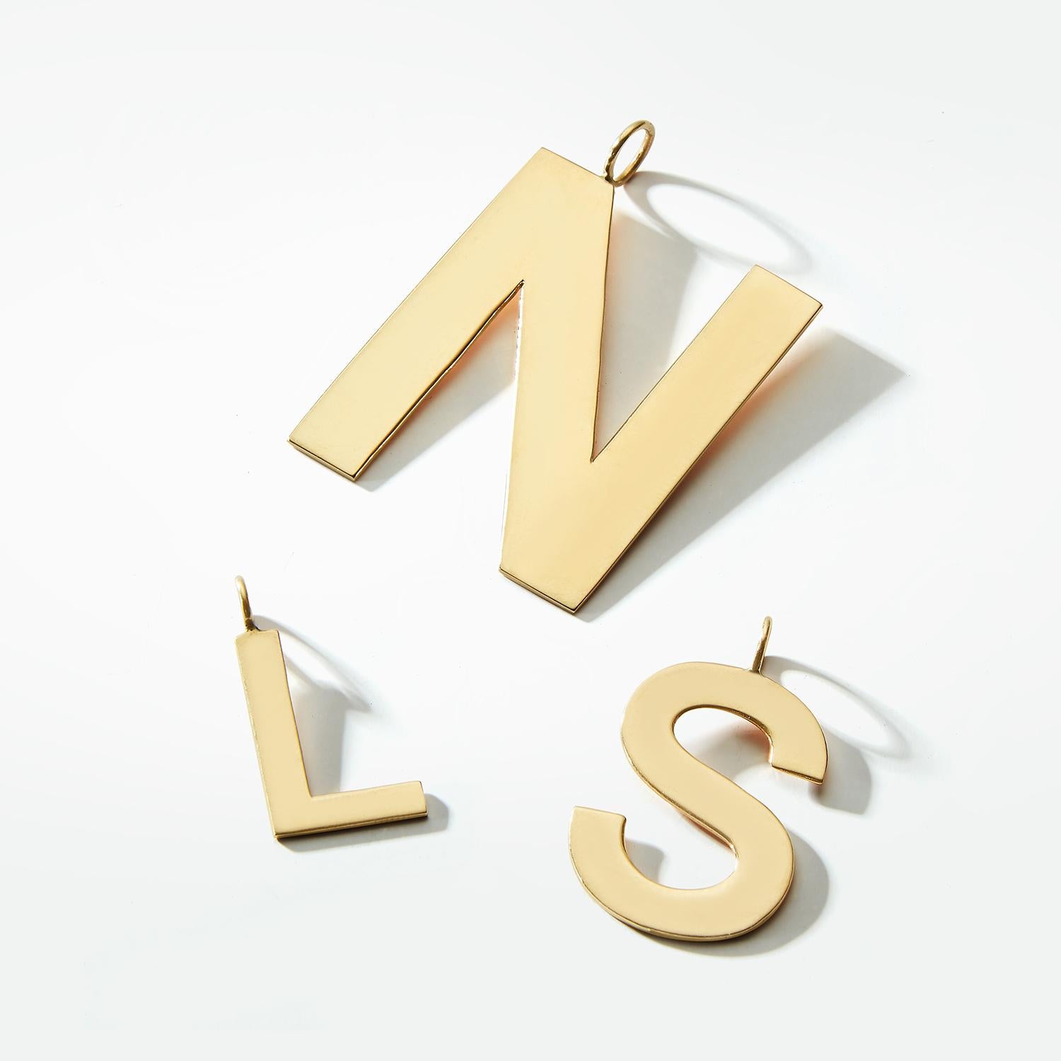 Our Medium Initial Charm Medallions make a big impact. Each block, solid gold letter is meticulously custom made by hand. They are available in every capital letter of the alphabet or single number. We love them for their dynamic look in an