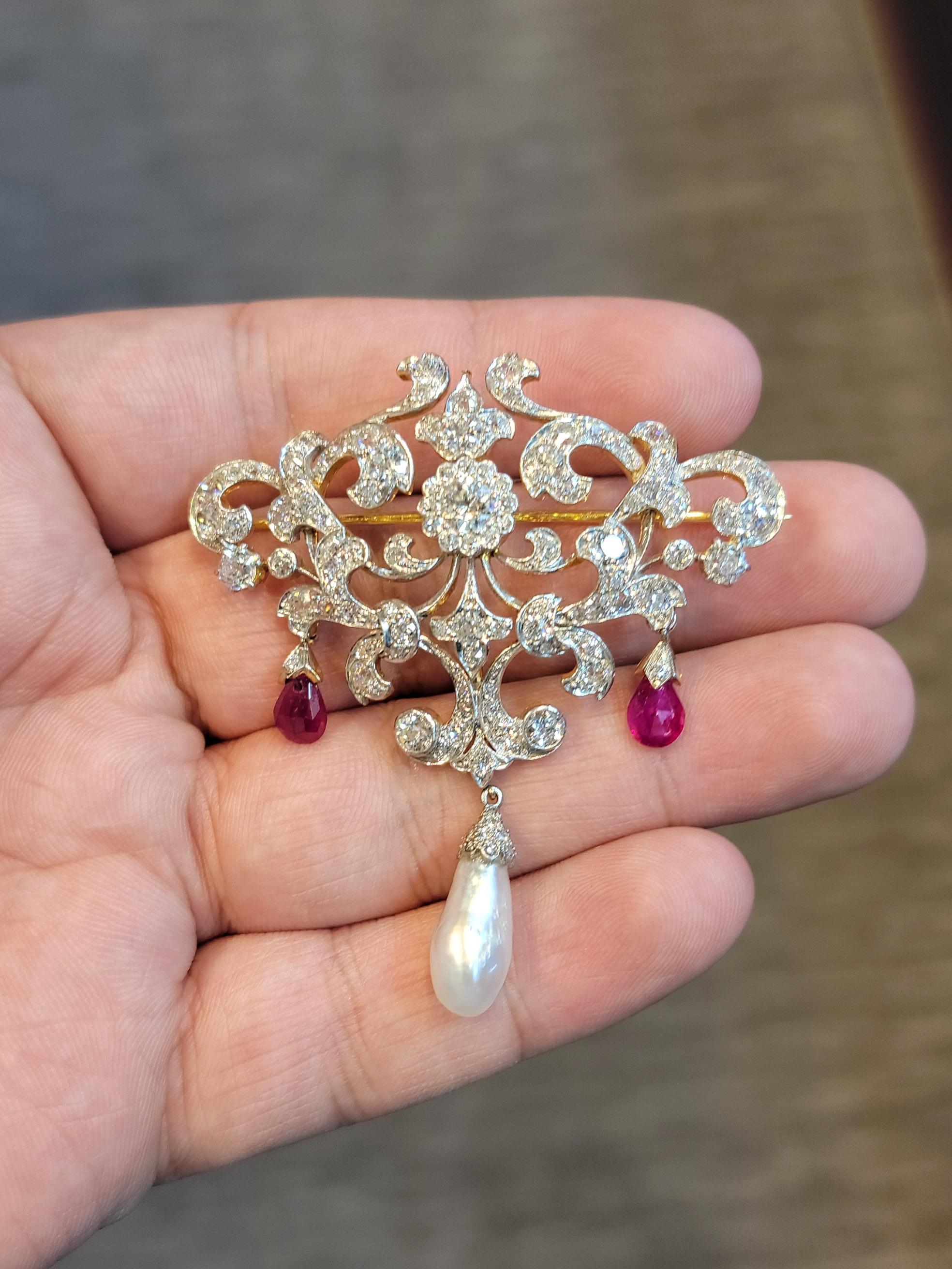Garland Style Antique Pearl and Ruby Brooch

One cultured pearl drop
Approximate Weights:
2.7 ct. of Rubies
.50 ct. Euro Cut Diamond in Center
6.7 ct. of Diamonds

Madee Circa 1900

Set in Platinum and 18k Gold