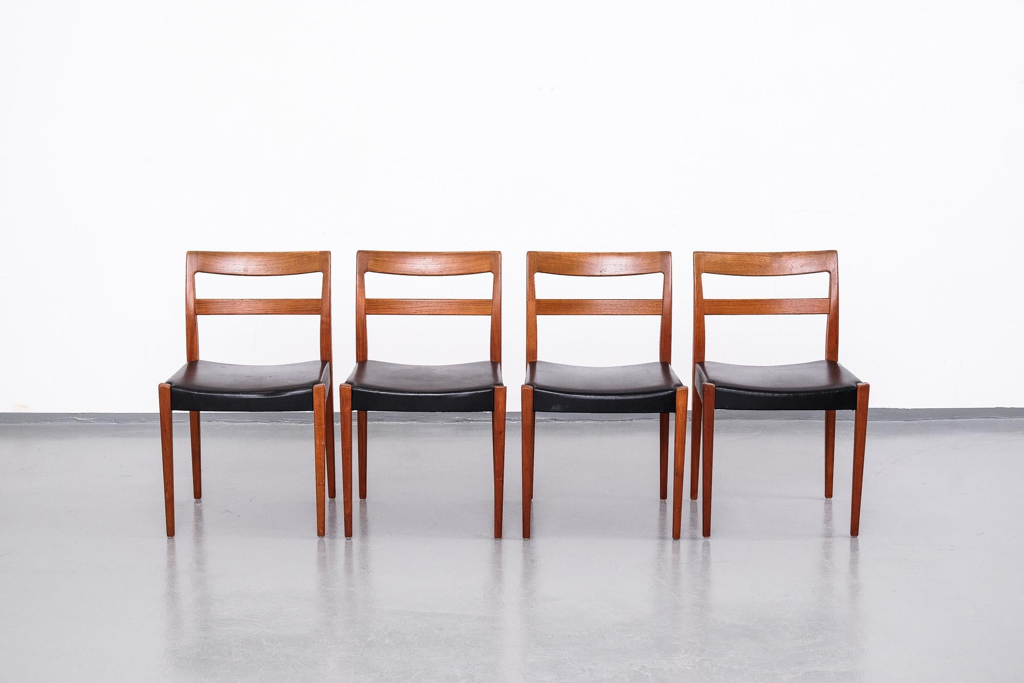 Set of four midcentury teak dining chairs designed by Nils Jonsson for Troeds, Sweden. This model is called Garmi.

Very good vintage condition with signs of usage consistent with age. Original black leatherette upholstery.