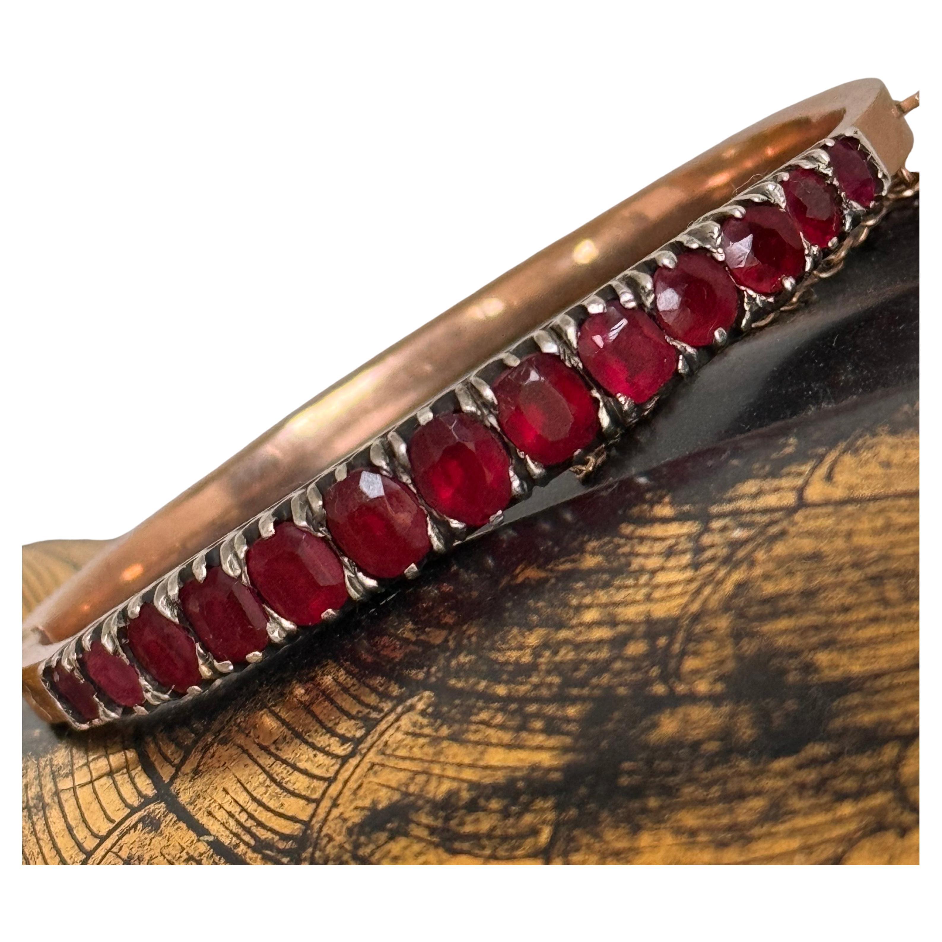 This stunning hinged bangle bracelet features deep, rich garnets in a captivating pomegranate hue, making it a true statement piece. The garnets are prong-set in silver with a closed-back setting, allowing their natural beauty to shine through. The