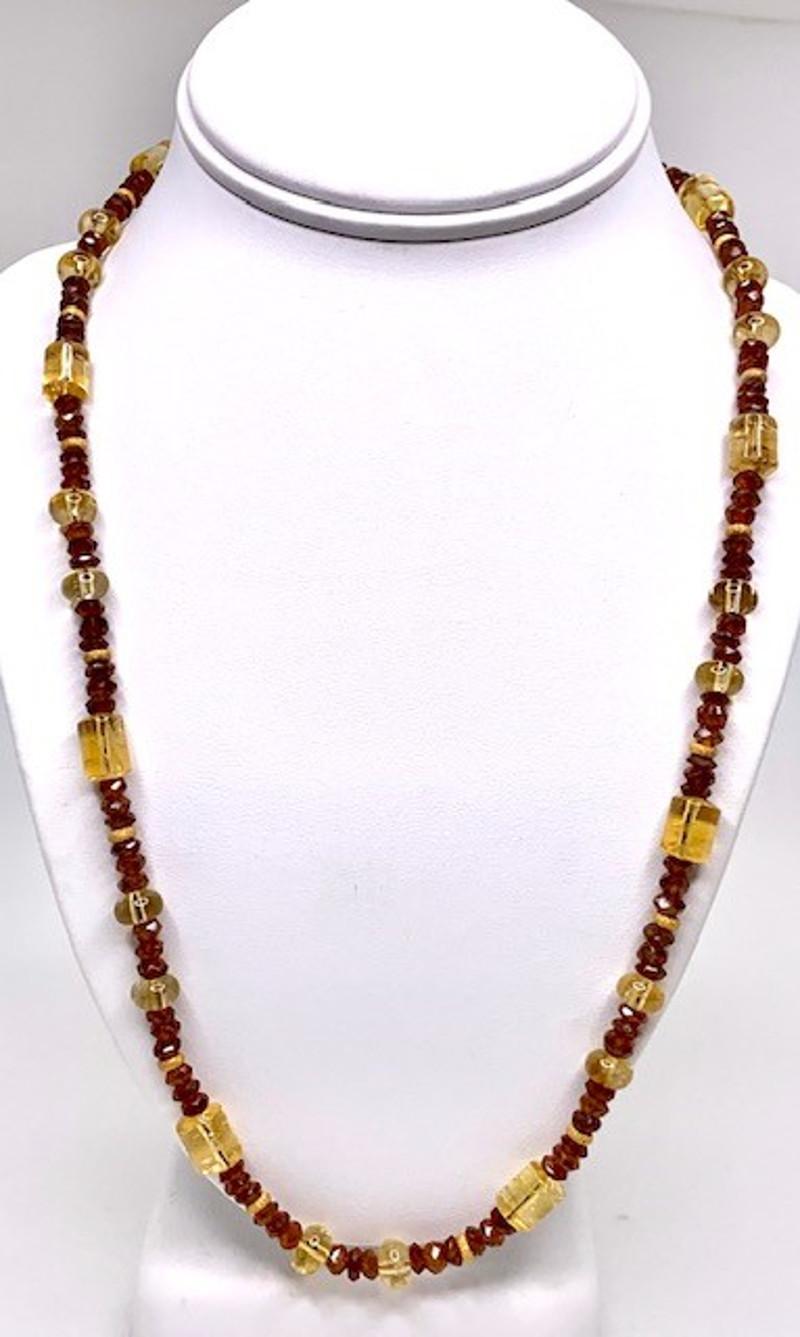 A fun garnet and citrine necklace is sure to lift your spirits! 5mm faceted hessonite garnets, known for their warm cinnamon color, are complemented by rondelle and barrel-shaped citrine beads, and accented with 14 karat yellow gold spacers. This
