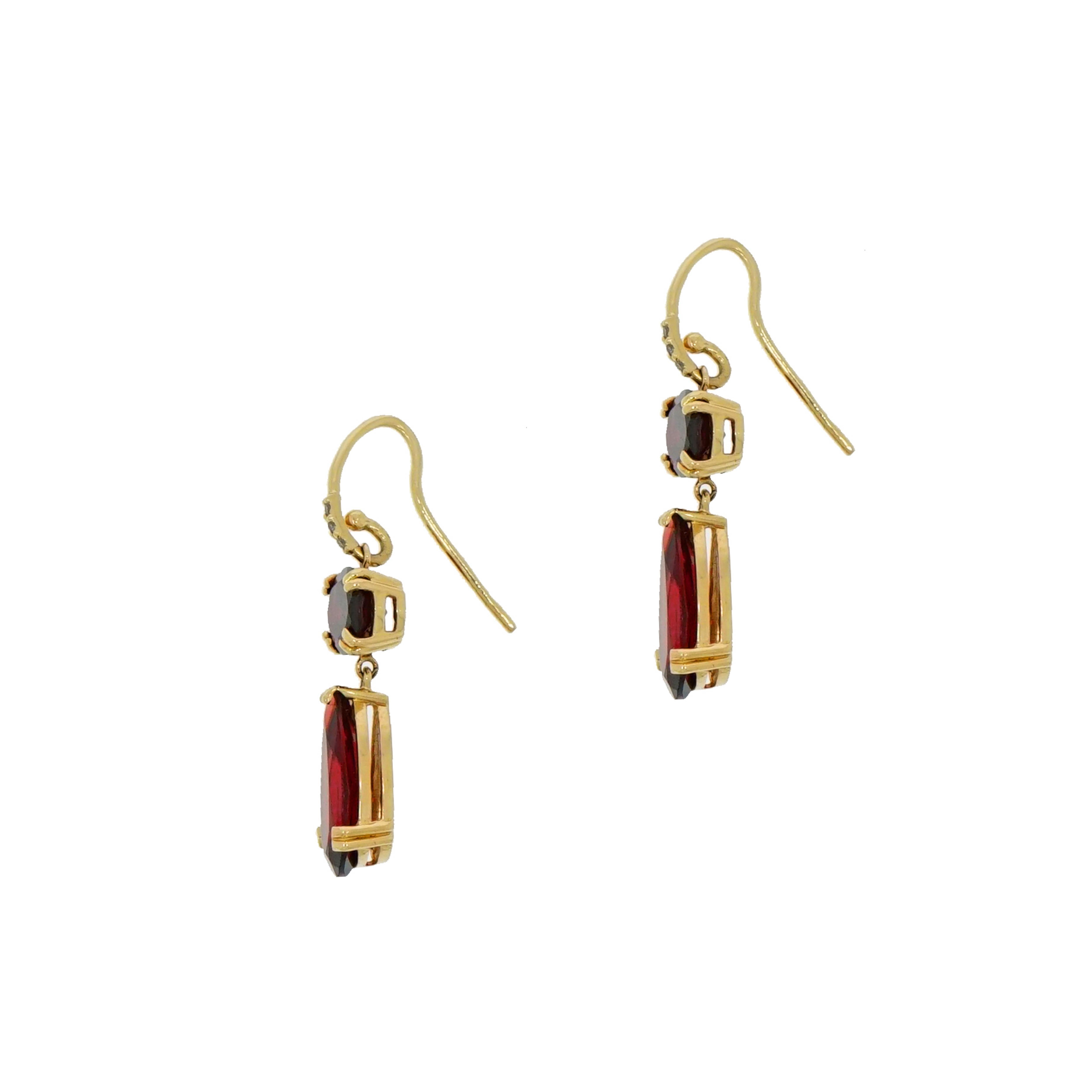 Dangling drops earrings comprised of oval and pear shaped garnets being the essence of this pair of chandelier earrings.
Handcrafted in 14k yellow gold with a wire/hook closure accented with diamonds.
Just the perfect amount of sparkles!!