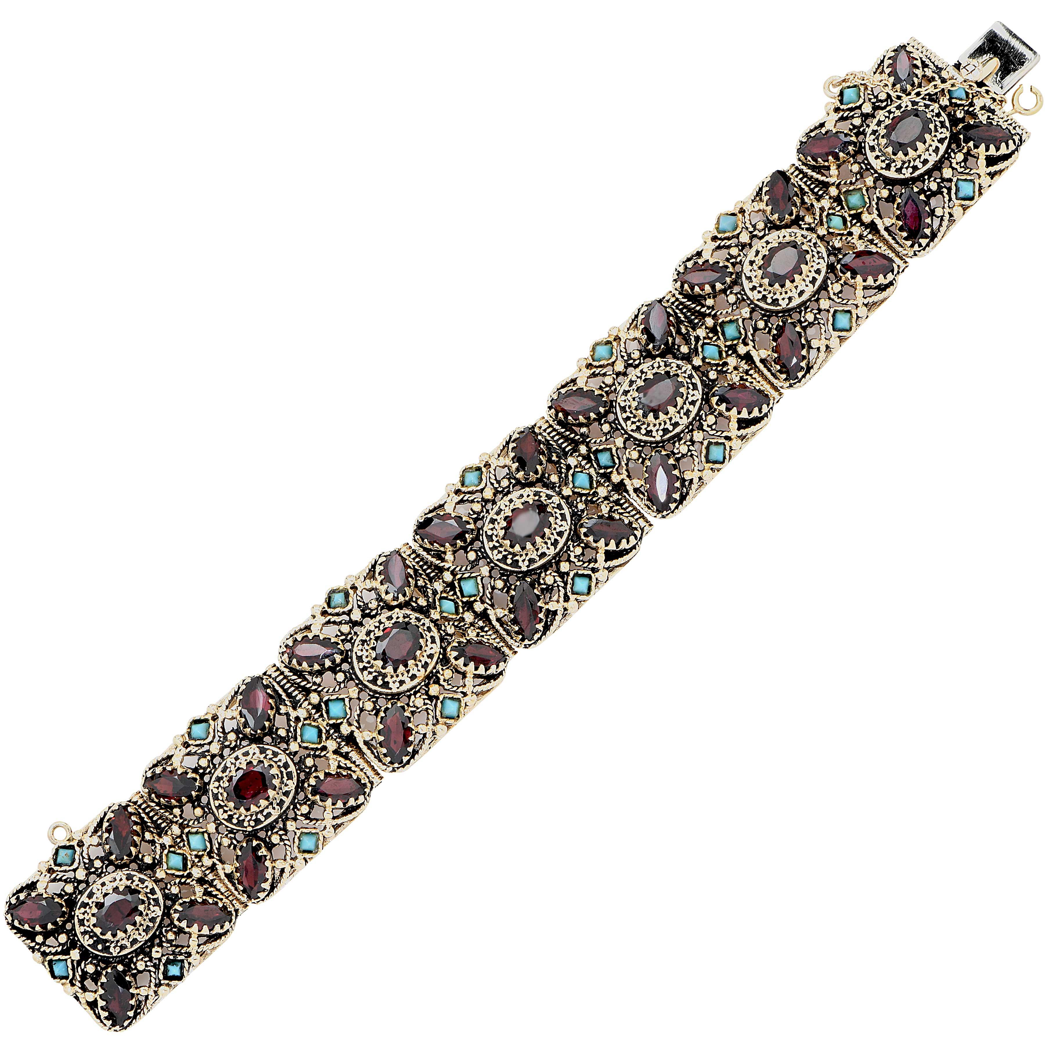 This Eclectic design features 35 oval cut garnets and 28 cabochon cut turquoise set in 14 Karat Yellow Gold. Circa 1970's
Bracelet Length: 6.75 Inches
Bracelet Metal Weight: 75.5 Grams
Metal Type: 14 Karat Yellow Gold