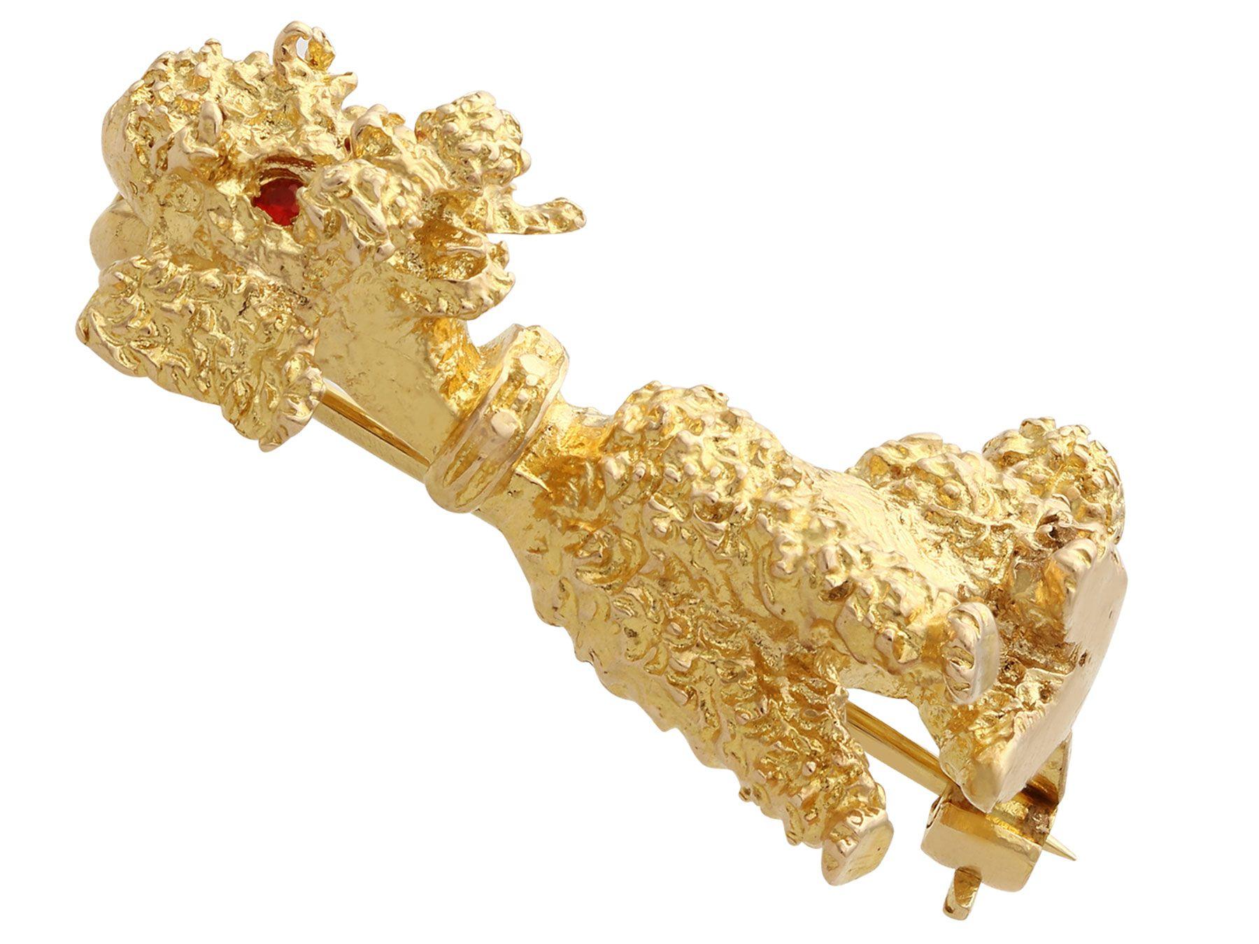 An impressive vintage English 0.03 carat garnet and 9 karat yellow gold 'poodle' brooch; part of our diverse vintage jewelry and estate jewelry collections.

This fine and impressive 9 k yellow gold brooch has been modelled in the form of a sitting
