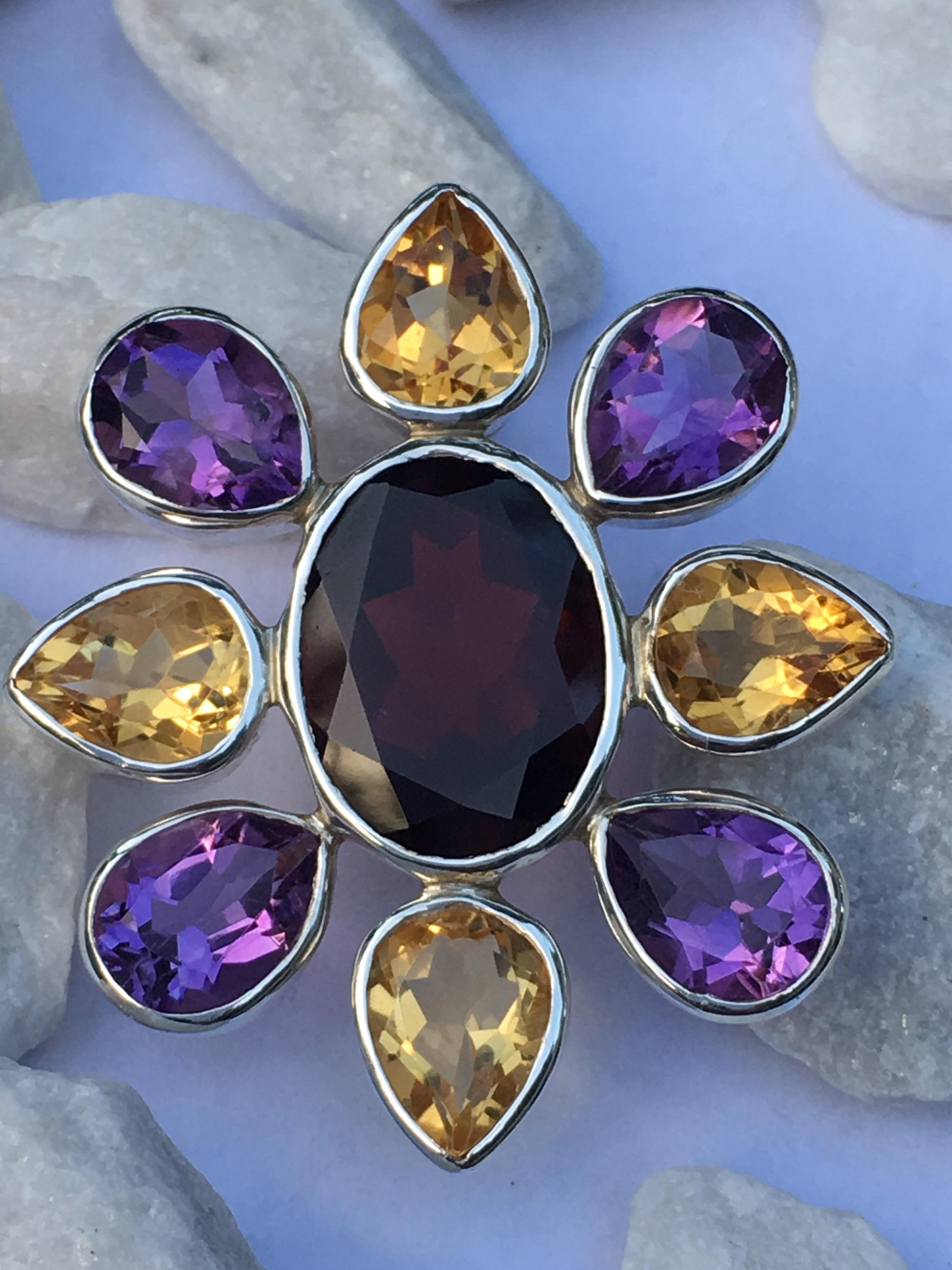 Large Garnet ( 12 MM X 16 MM ) set in sterling silver with Amethyst and Citrine ( 7MM X 9 MM) Pendant.


Weight of the pendant is 13.38 Gram ,measures 36 MM X 33 MM.


This pendant can be worn on Leather band or silver chain.


