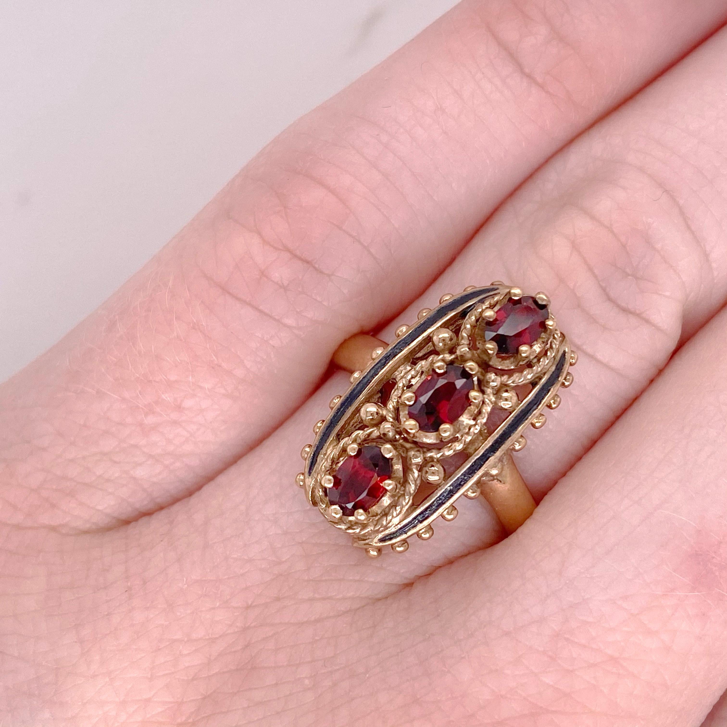 The estate piece has three oval garnet gemstones set in six prongs each. The gemstones are set with character and have been well taken care of. This estate ring is in excellent condition with all original stones and gold. The ring is elongating and