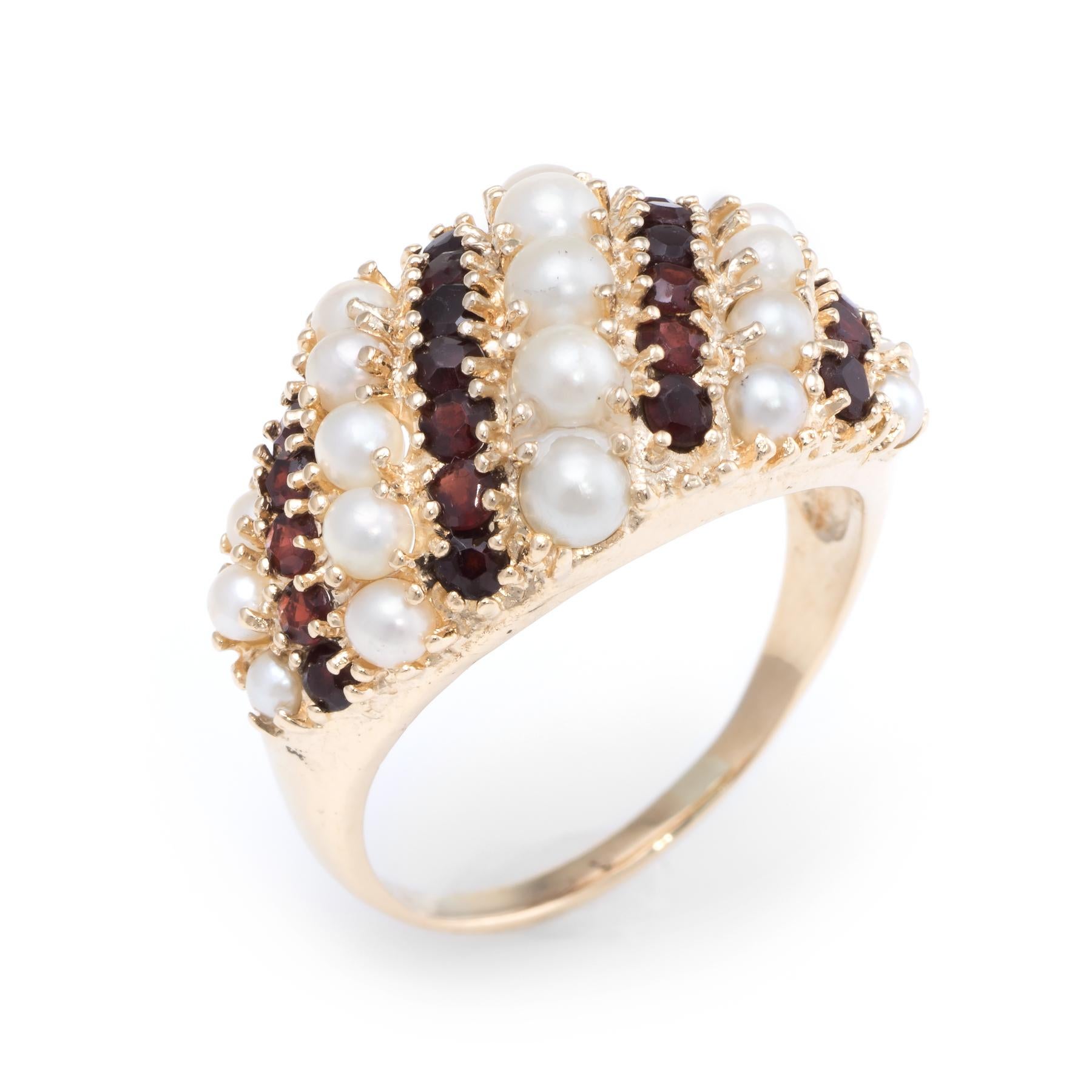 Finely detailed domed band, crafted in 14 karat yellow gold. 

Garnets total an estimated 1.25 carats, accented with cultured pearls that graduate in size from 3-4mm. The stones are in excellent condition and free of cracks or chips.   

The medium