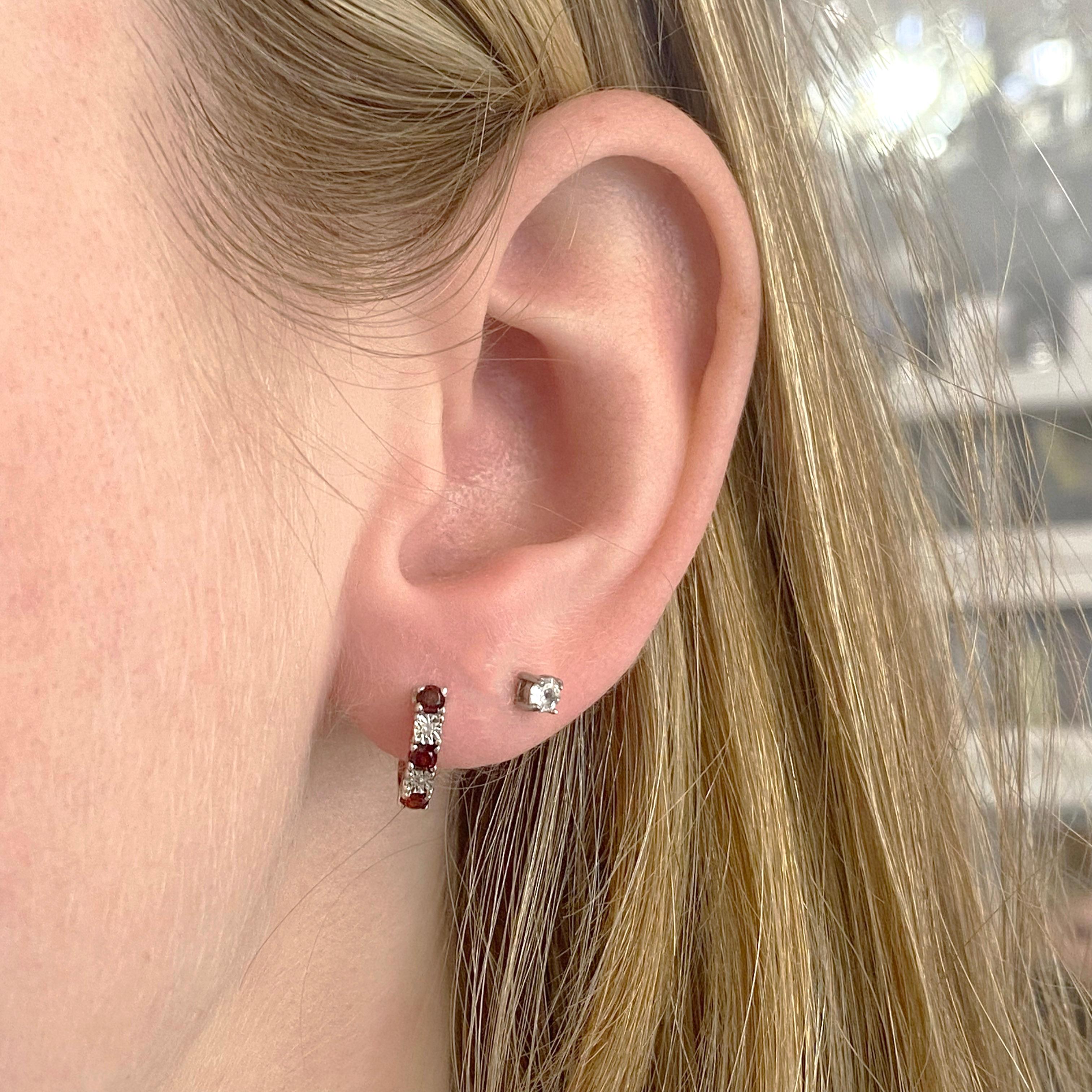 Earrings: 1 Set
Metal Quality: Sterling Silver With Rhodium Plating
Earring Type: Hoops/Huggies
Clasp Type: Hinge
Hoop DIameter: 12.32 millimeters
Earring Width: 3.02 millimeters 
Diamond Number: 2
Diamond Shape: Round
Diamond Diameter: 1.02