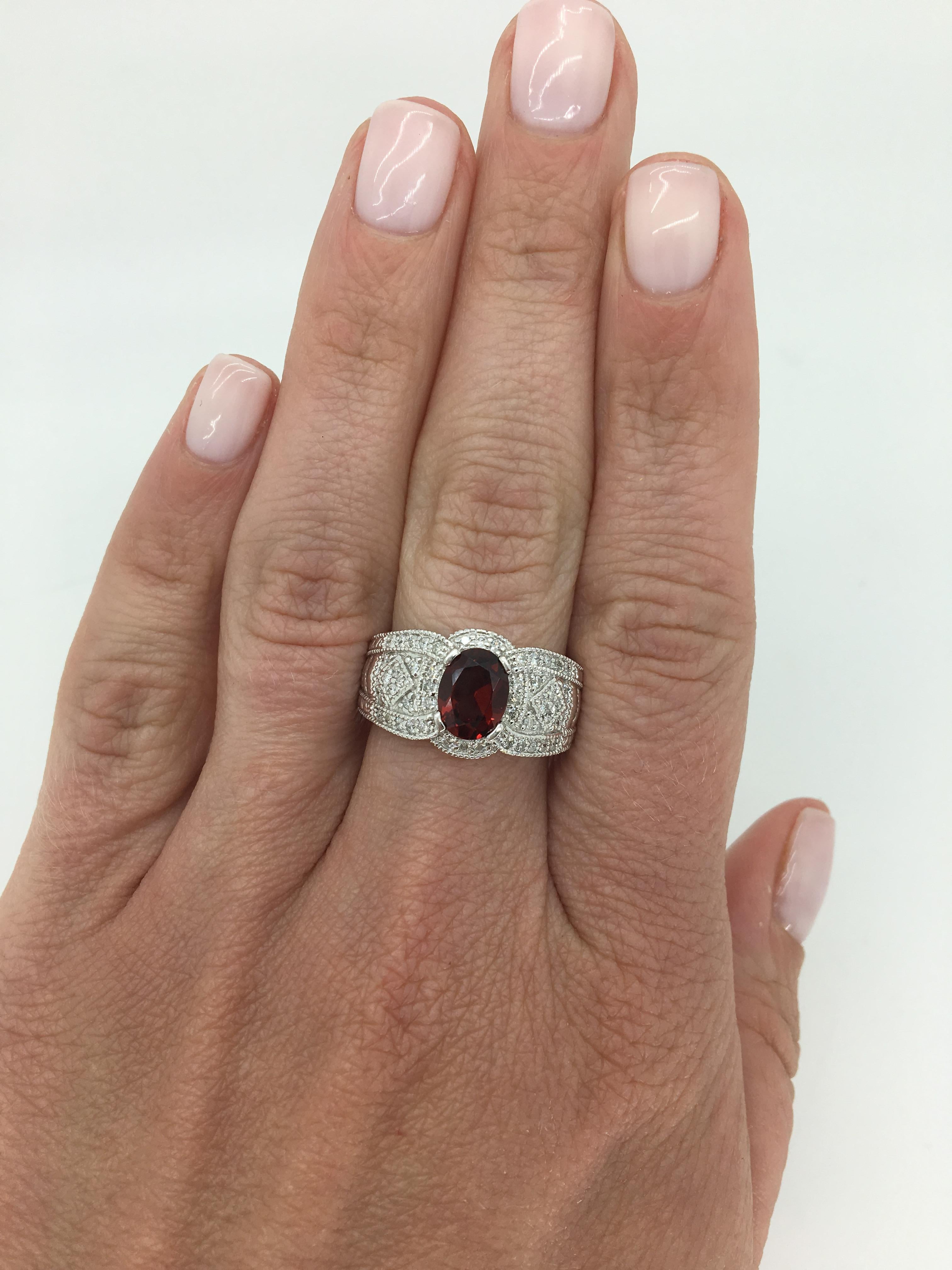 Filigree detailed Garnet and Diamond ring crafted in 14K white gold.

Gemstone: Garnet and Diamond
Gemstone Carat Weight: Approximately 8x6mm Oval Cut
Diamond Carat Weight: Approximately .50CTW
Diamond Cut: Round Brilliant Cut
Color: Average