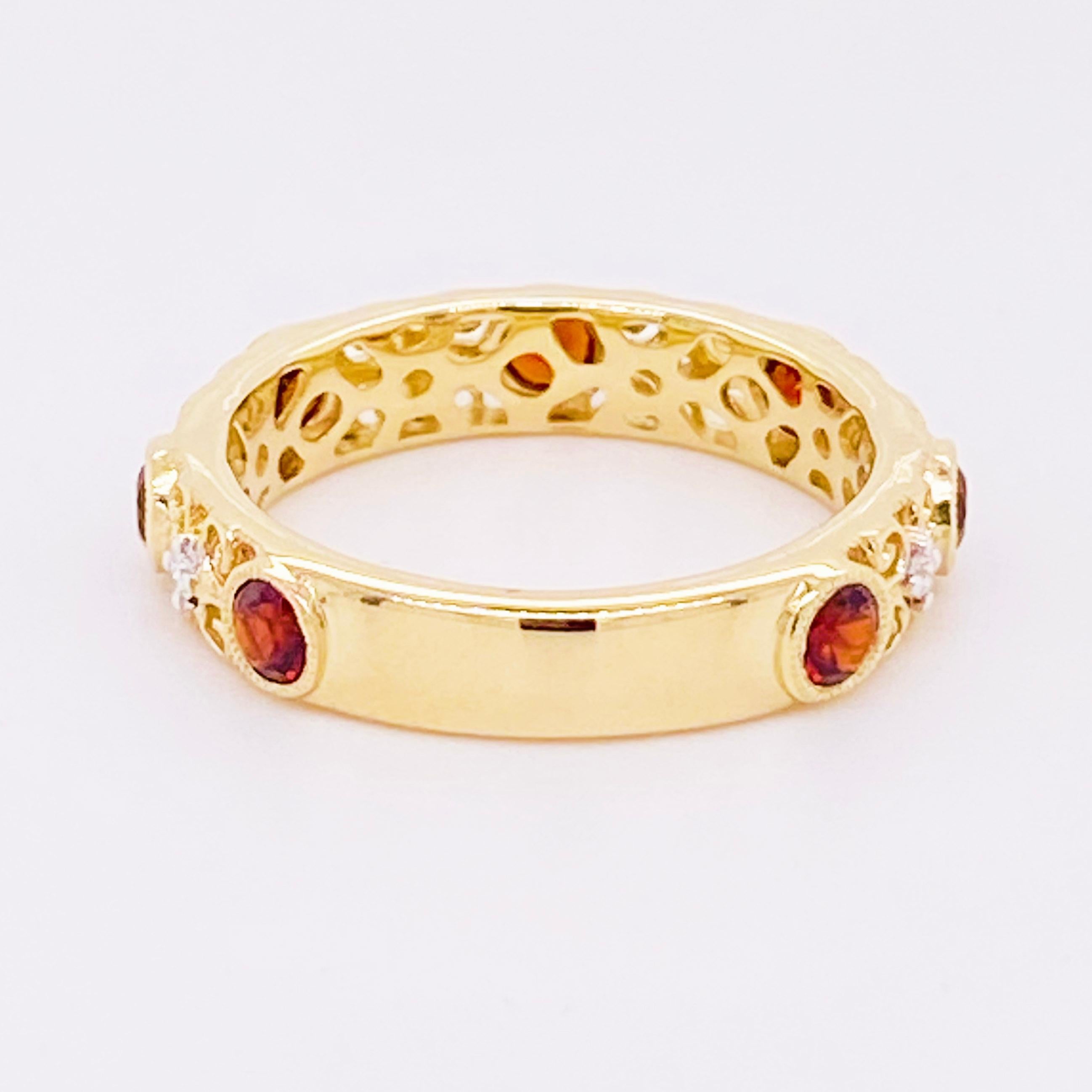 This lovely garnet and diamond band ring has a stunning detailed filigree design! Accented by lovely 14 karat yellow gold, this ring is an amazing fashion band and stackable band!  This pairs well with most engagement rings and wedding bands as