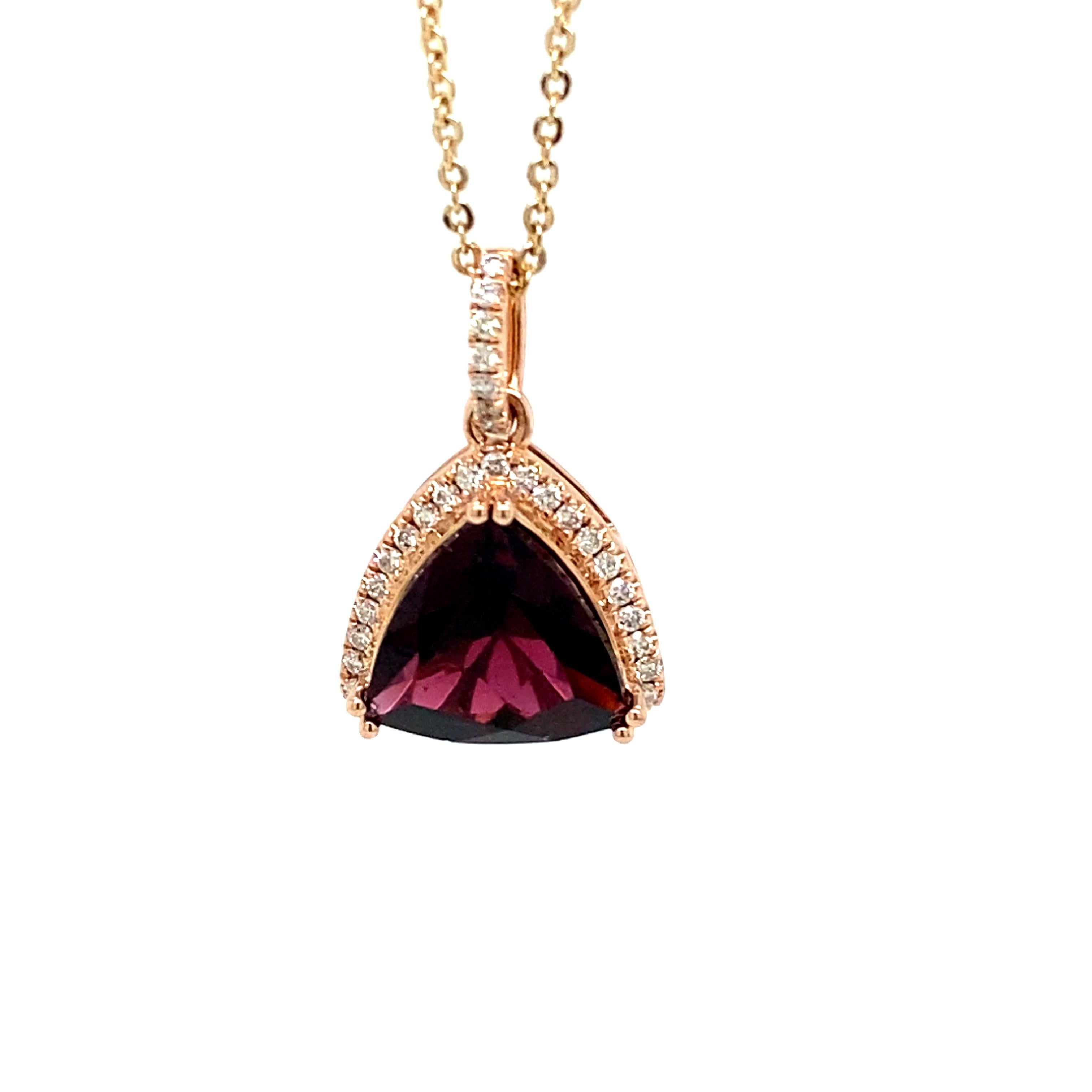 Trillion cut garnet is framed by a halo of diamonds, The pendant has pave setting of diamonds and has a beautiful back gallery. Crafted in 14K Rose Gold is an elegant piece of jewelry.
Weight of Garnet: 7.5ct approx
Weight of Diamond: 0.48ct 
*