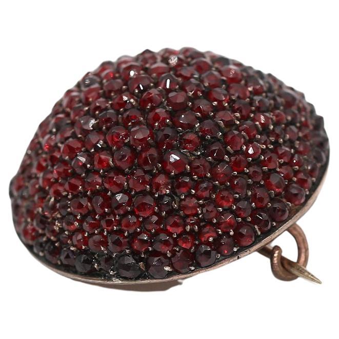 Garnet Dome Brooch, was created around 1890.

19th-century Garnet half sphere brooch with a massive amount of fine garnet stones. 

Has a  wash or filled mounting. 19th-century Garnet brooch. It is amazing how this wonderful 19th-century antique