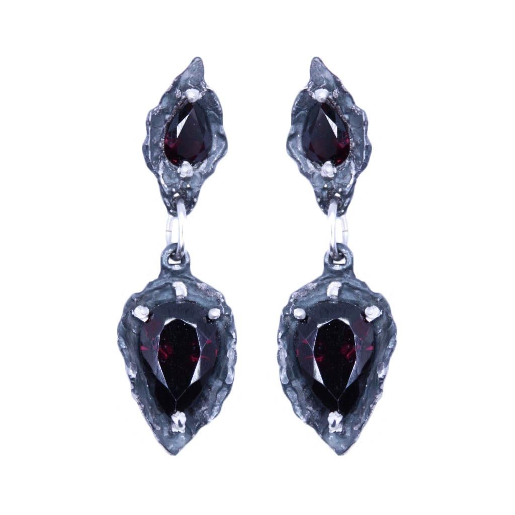 These earrings cradle these beautiful faceted stones in hand carved silver.  These drop earrings have sterling silver post backs and are solid sterling with garnet pears. 

These are beautiful statement pieces- if you would rather a hook ear wire