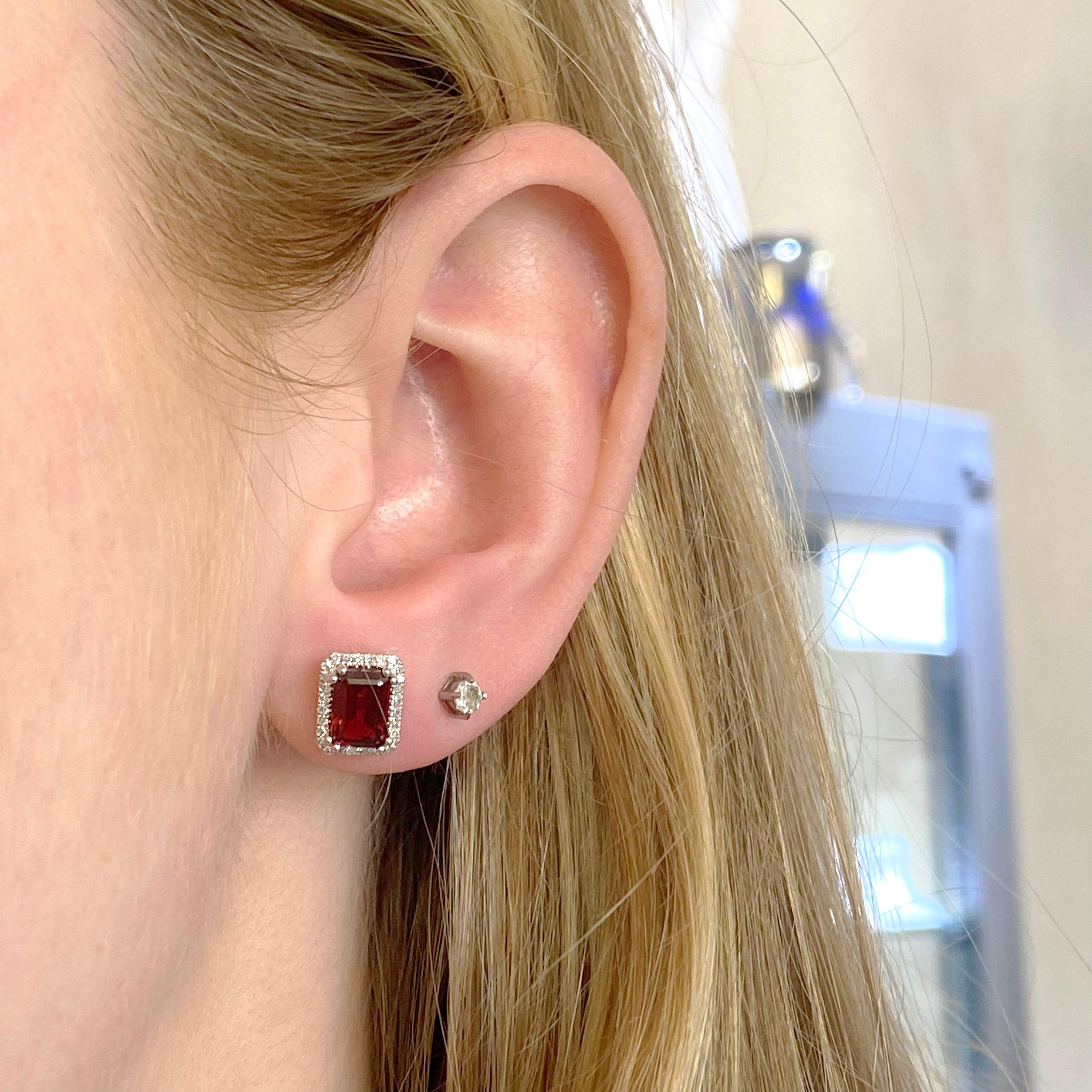 These emerald cut garnet earrings have 28 diamonds going around each gemstone. The diamonds are all natural and each have top color and clarity for maximum brilliance and sparkle! Garnets are a gorgeous red color and are a great staple to any fine
