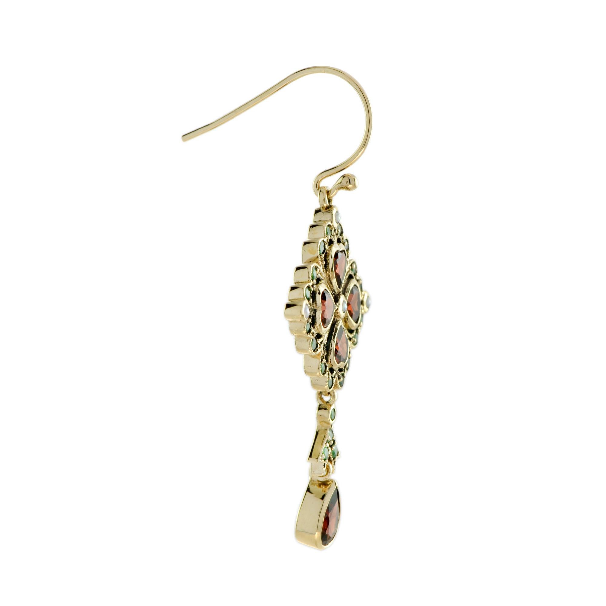 This dangle earrings are all you need on your spring day! Made in 9k yellow gold, the top part of these earrings are peal, garnet and emerald. The fusion of the yellow gold with the green and red shades of the stones makes these earrings exquisitely