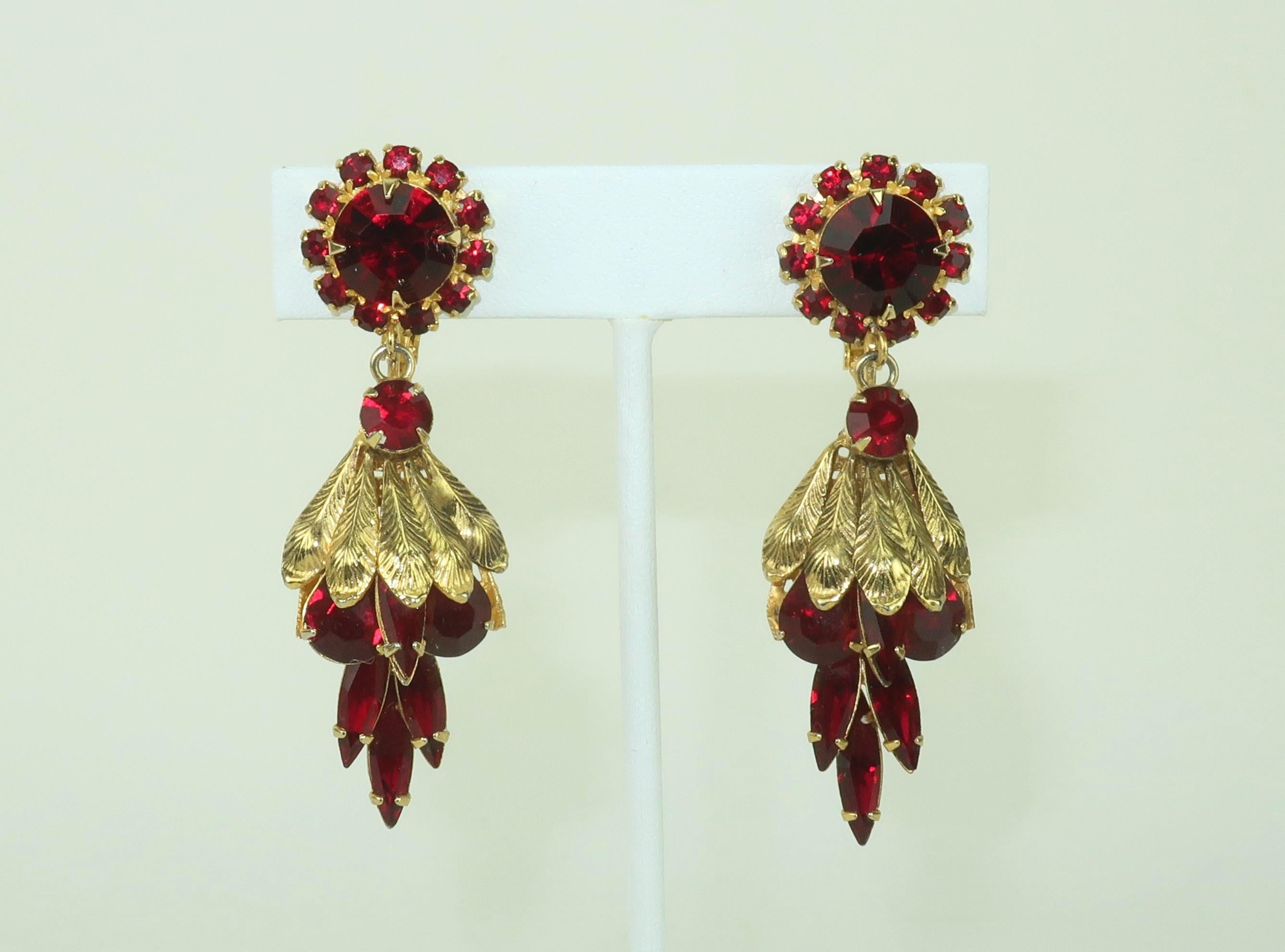 1960’s drop dangle gold tone earrings embellished with garnet red glass rhinestones.  The style and filigree work are reminiscent of Edwardian designs.  Outfitted with adjustable screw back clip-on hardware.  No apparent hallmark though well made