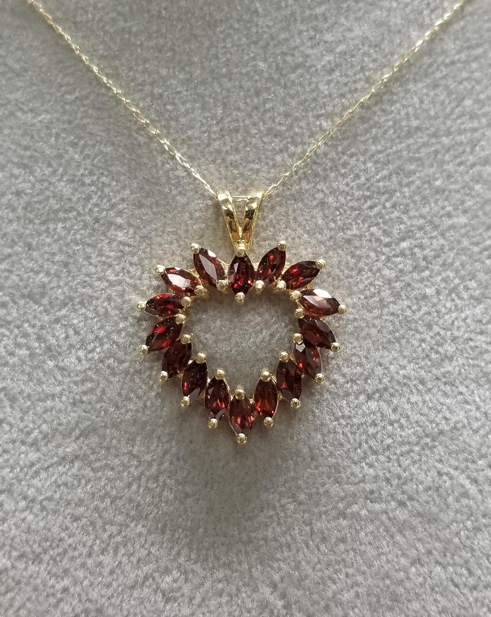 10k yellow gold Garnet Marquise heart pendant containing 16 marquise cut garnets weighing 2.40cts. on a 17 inch chain.