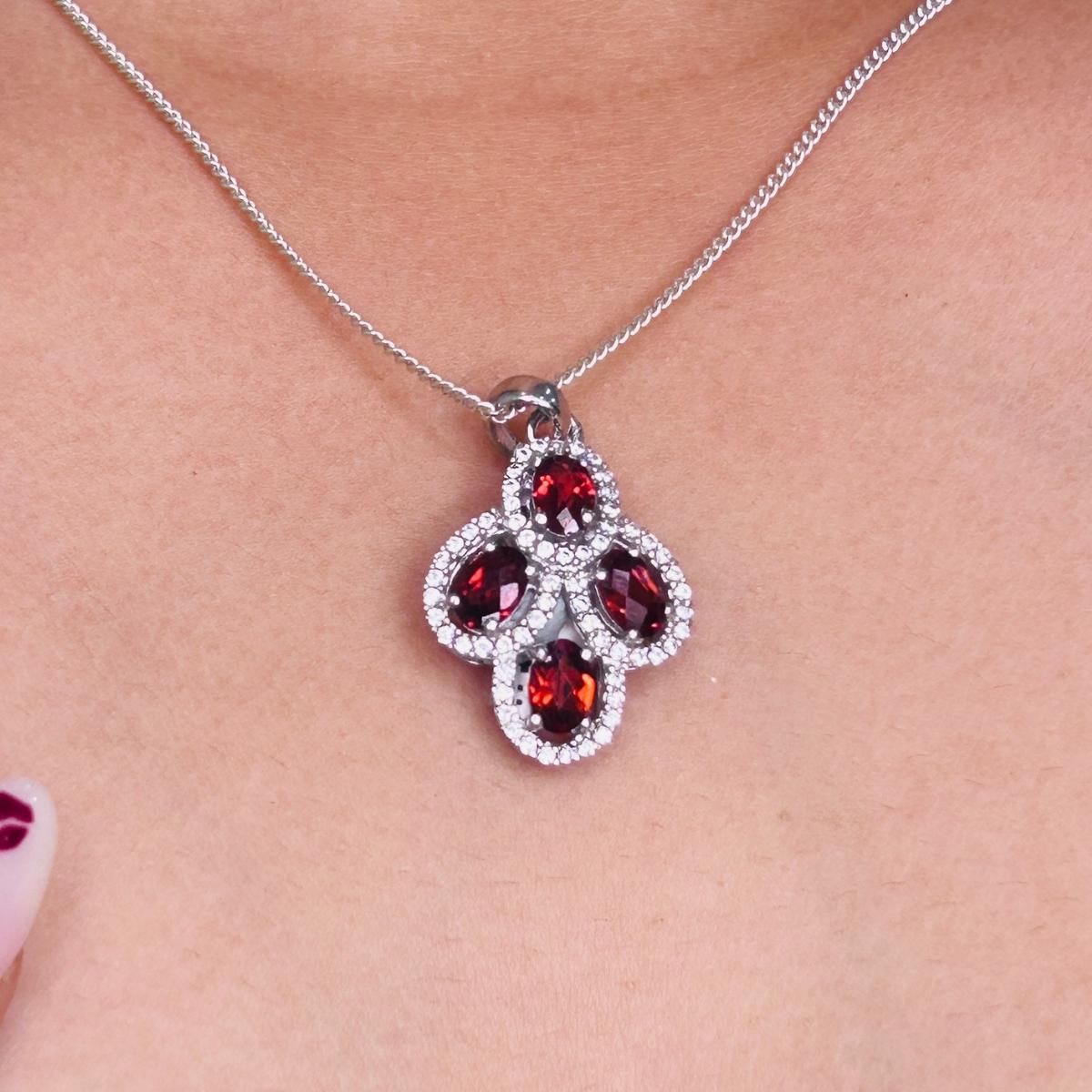 925 sterling silver, offering a perfect balance of elegance and durability. At the heart of the design are four exquisite natural garnet gemstones, totaling 2.58 carats. Their rich, deep red tones symbolize passion, vitality, and timeless beauty.