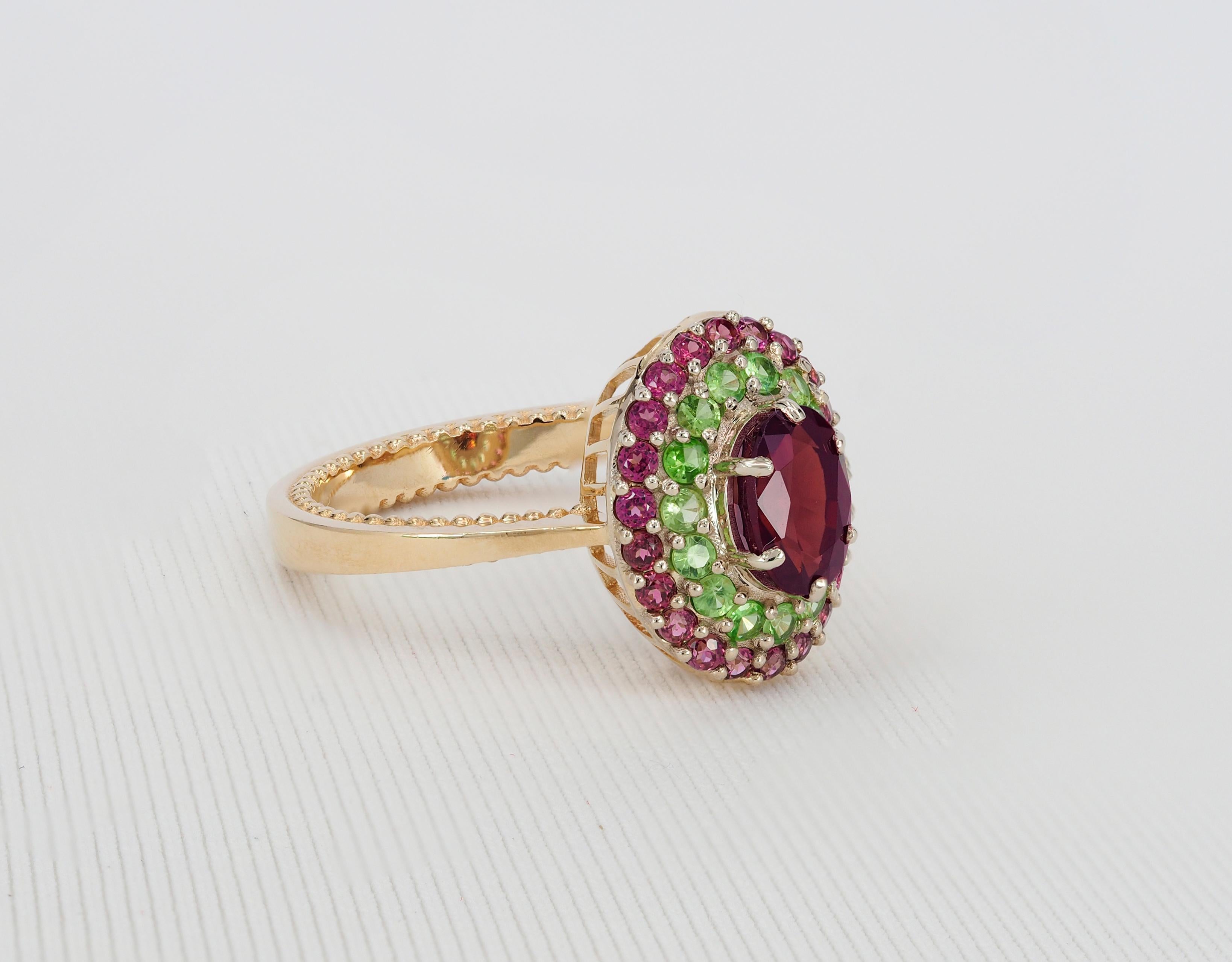 Modern Garnet ring with side tsavorites and rubies. For Sale