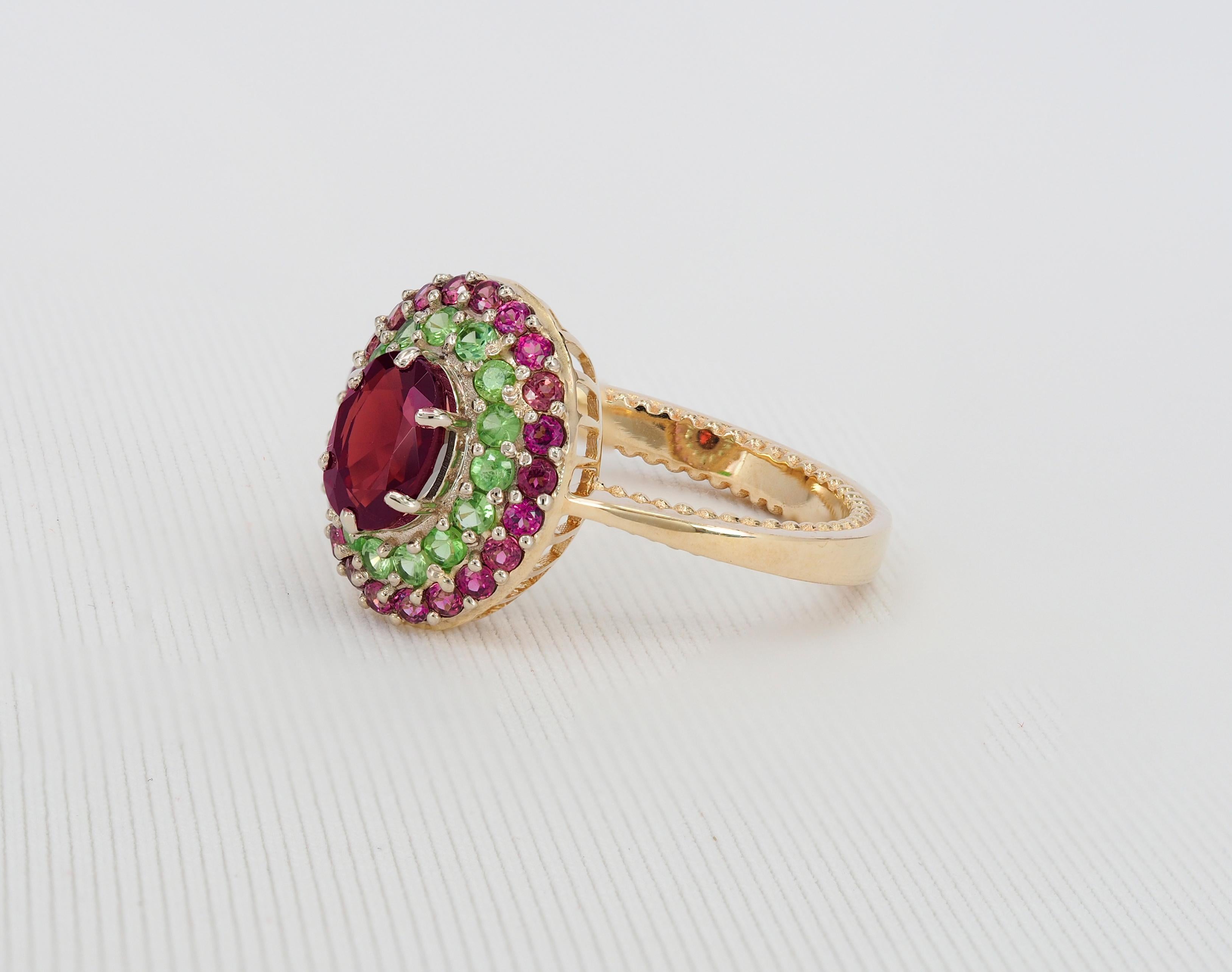 Oval Cut Garnet ring with side tsavorites and rubies. For Sale