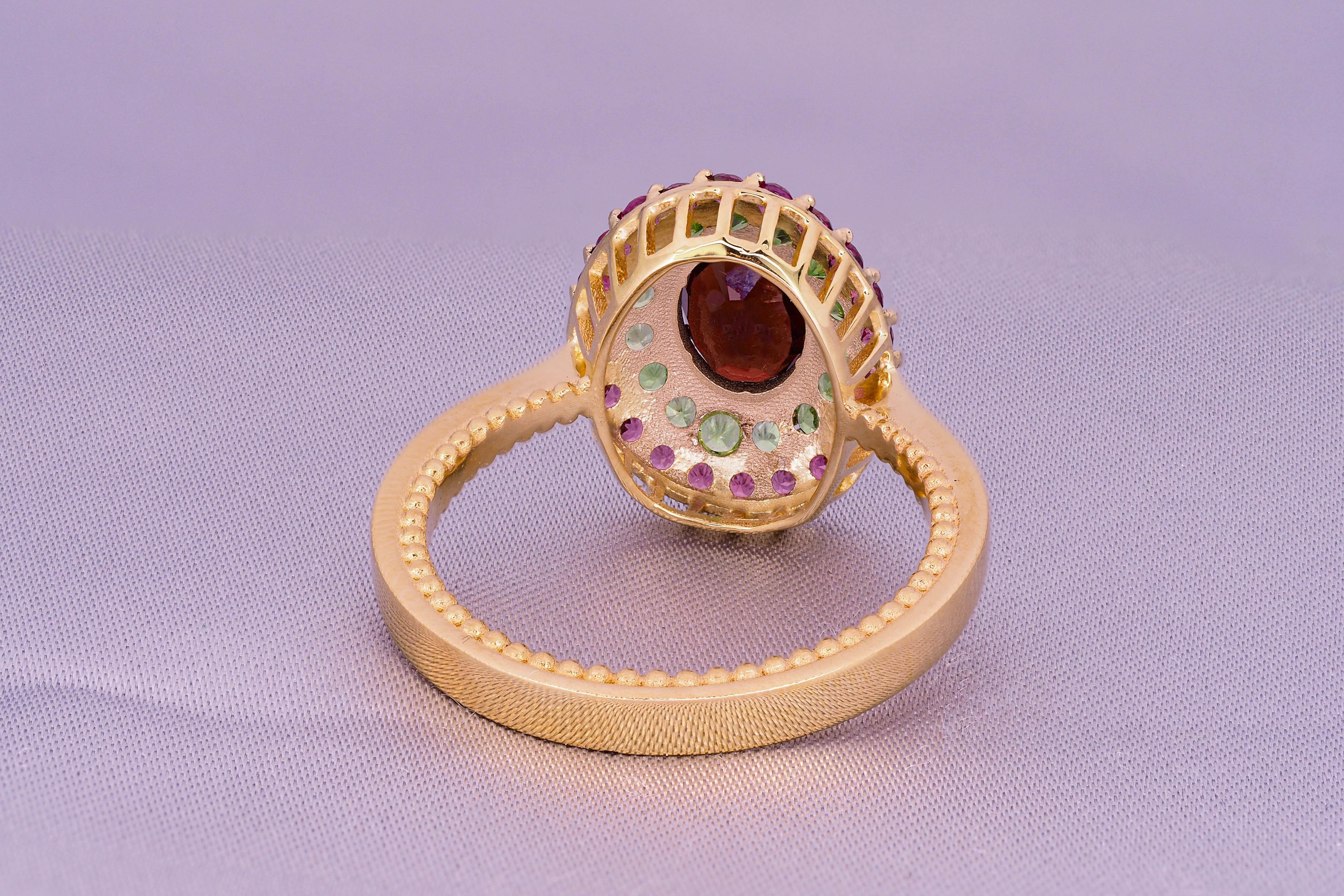 Oval Cut Garnet ring with side tsavorites and rubies. For Sale