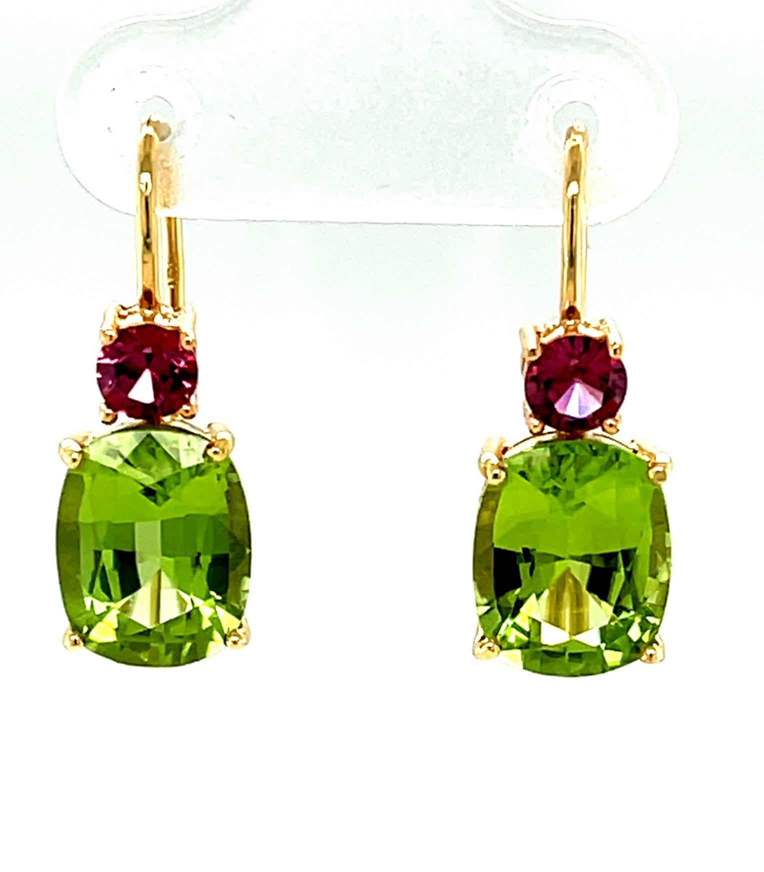 These gorgeous color-blocked earrings are simple in design and simply stunning! It's all about the gemstones. Two grass-green peridots (5.76 carats total) are paired with two fuschia-pink garnets (.60 carats total). Color, shape, design and