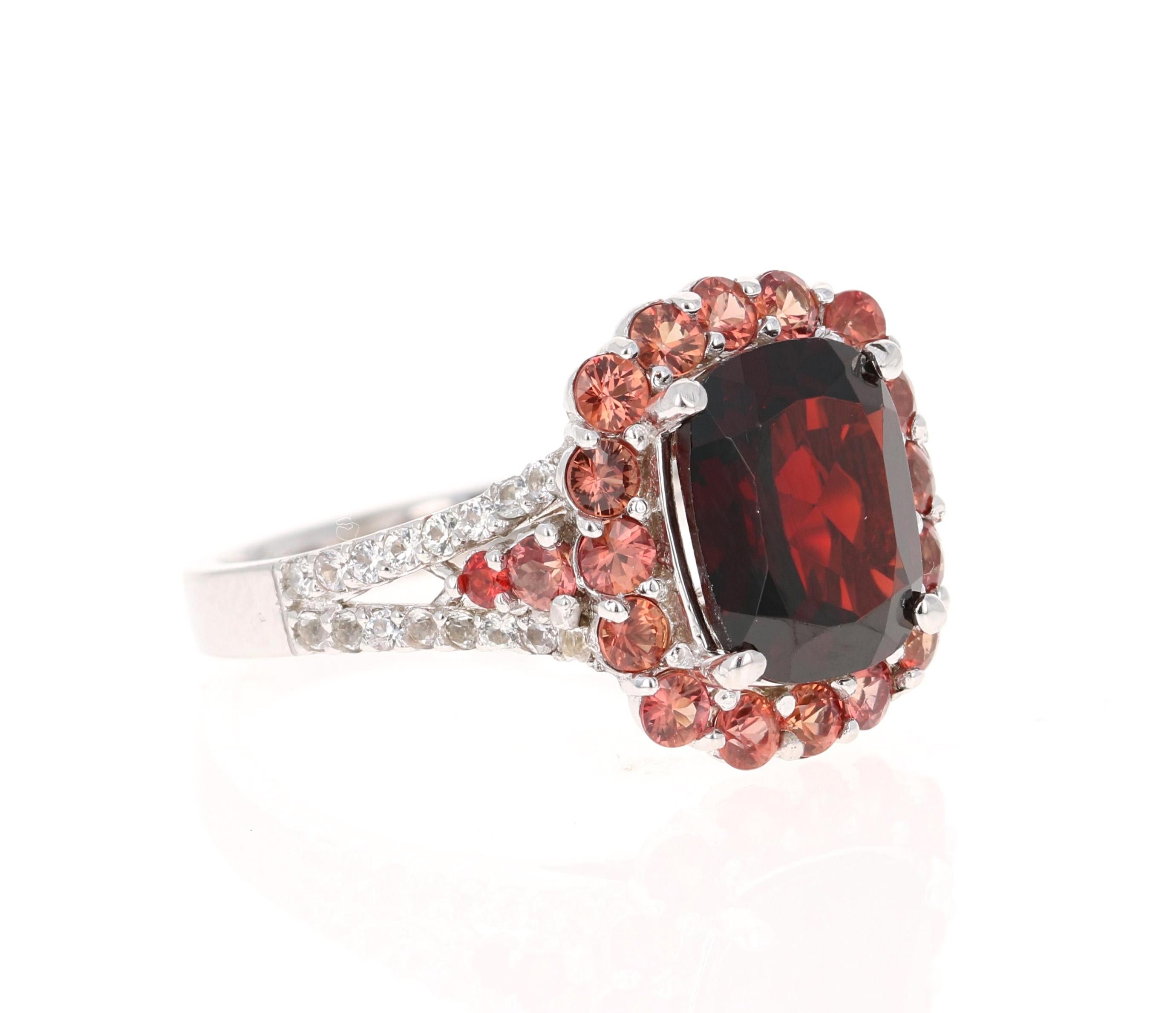 This ring has a Cushion-Oval Cut Garnet weighing 3.42 carats and is surrounded by 19 Round Cut Natural Red Sapphires weighing 1.04 carats. Additionally there are 32 Round Cut White Sapphires that weigh 0.35 carats. The total carat weight of the ring
