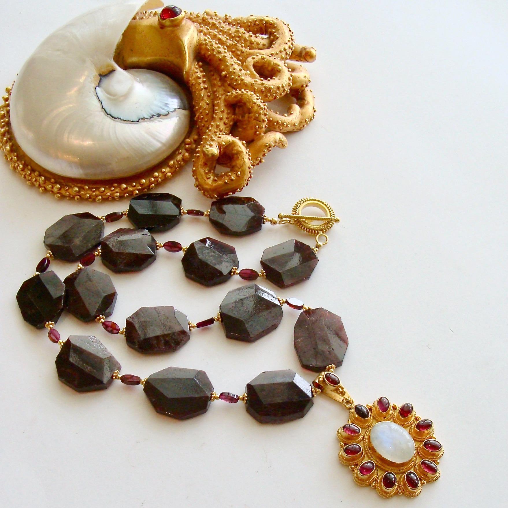 A unique suite of raw, yet faceted garnet slices, displays the beauty of these generous stones and their deep rich color.  These semi-precious gem stones become more approachable when they are shown in their more natural state - including striations