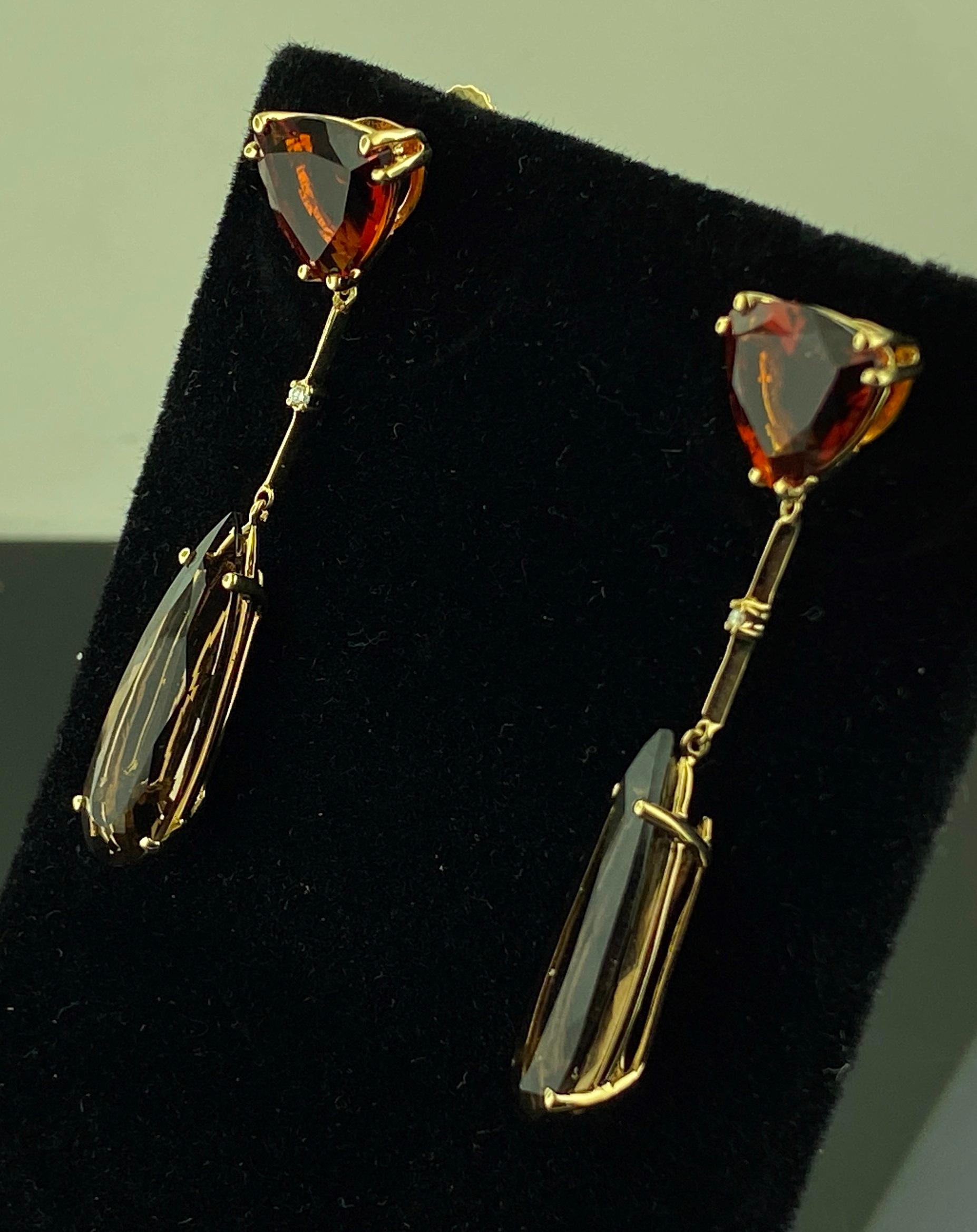 Set in 14 karat yellow gold, are two Triangle cut Garnets weighing 3 carats each, total 6 carats, with two long Pear cut Smokey Quartz dangling from garnet triangles, weighing 8.00 carats total, with two small Round Brilliant cut diamonds weighing