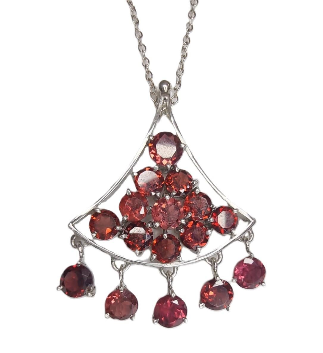 Introducing a stunning Garnet Pyramid Tassel Pendant, a captivating fusion of elegance and bold design. Crafted with meticulous attention to detail, this exquisite piece features a triangular pyramid-shaped pendant adorned with a dazzling array of