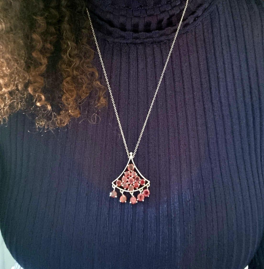 Introducing a stunning Garnet Pyramid Tassel Pendant, a captivating fusion of elegance and bold design. Crafted with meticulous attention to detail, this exquisite piece features a triangular pyramid-shaped pendant adorned with a dazzling array of