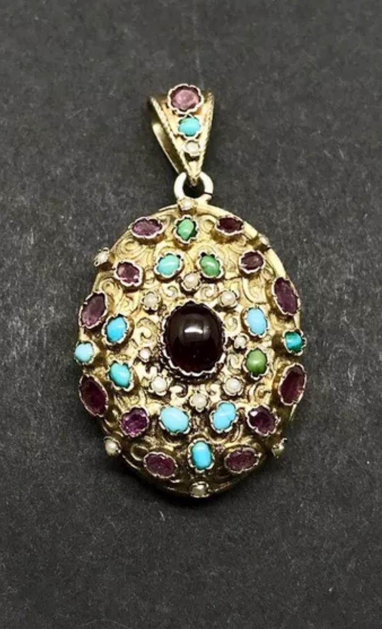 This Locket Pendant is a magnificent piece of Austro-Hungarian Garnet, Turquoise and Amethyst jewelry.  It is in the Renaissance Revival style and dates to circa 1870.  The gems are all set in silver gilt as was the custom of the Austro-Hungarian