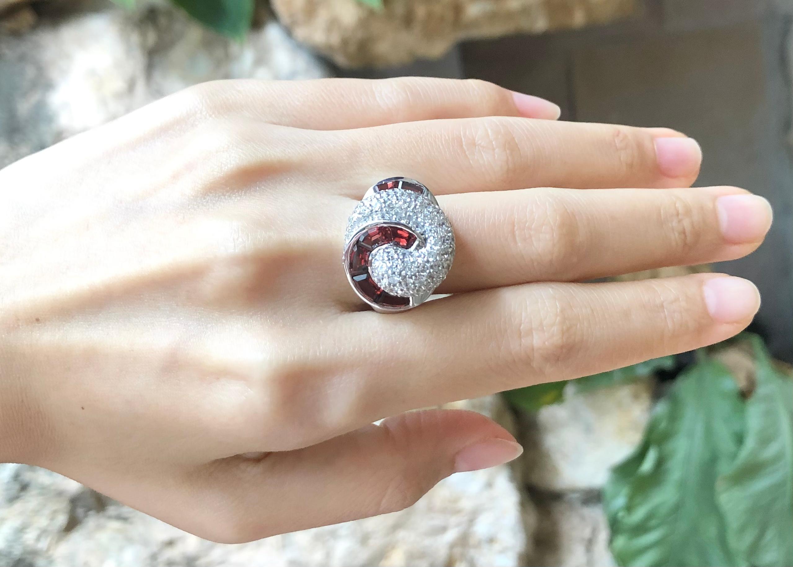 Garnet with Cubic Zirconia Ring set in Silver Settings

Width:  2.0 cm 
Length: 1.8 cm
Ring Size: 55
Total Weight: 9.42 grams

*Please note that the silver setting is plated with rhodium to promote shine and help prevent oxidation.  However, with
