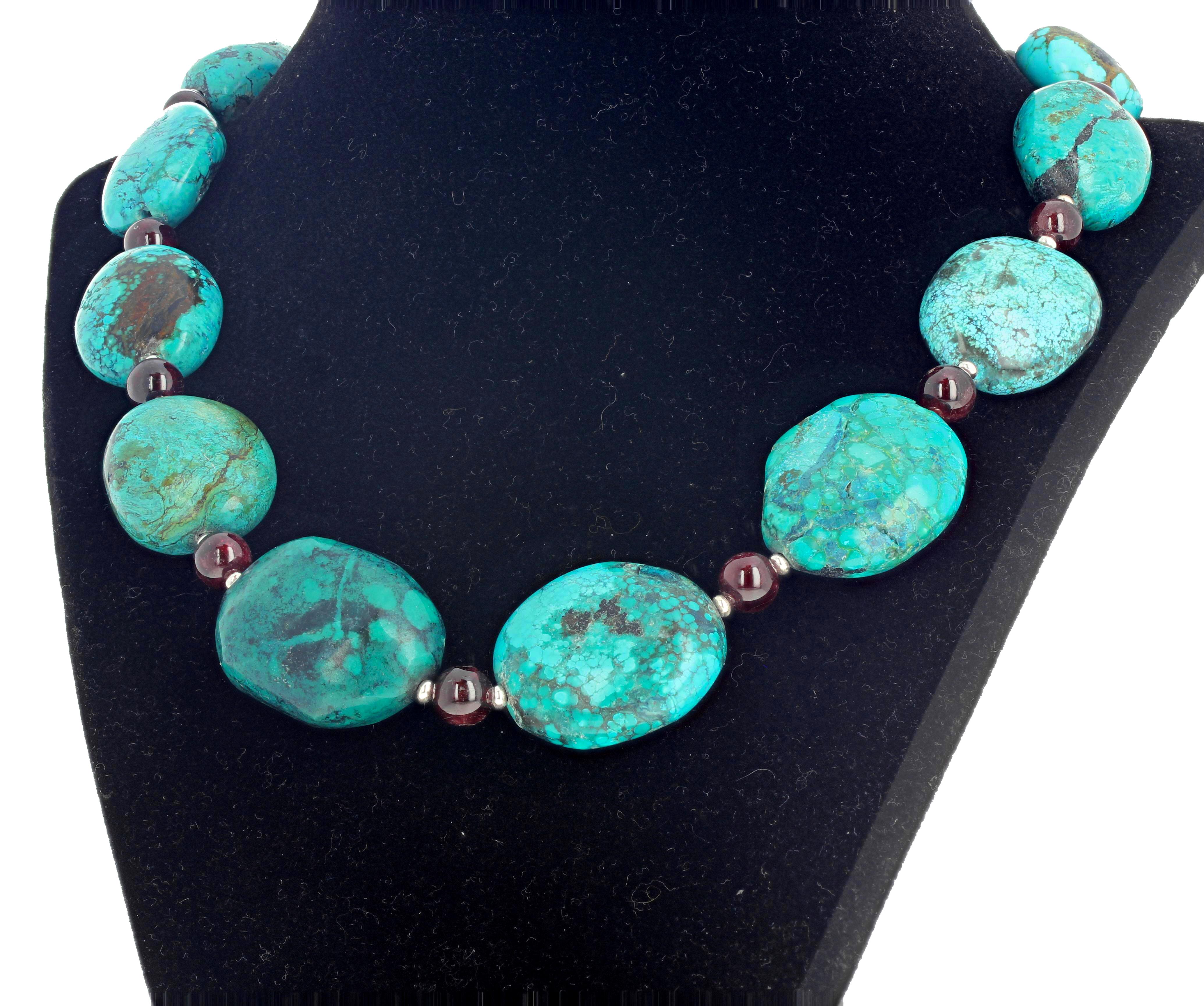 Beautiful polished round dark red glowing graduated Garnets enhance these artistic looking Turquoise set in this 19 inch long necklace with silver plated easy to use hook clasp.  The largest Turquoise is approximately 32 mm x 25 mm.   If you wish