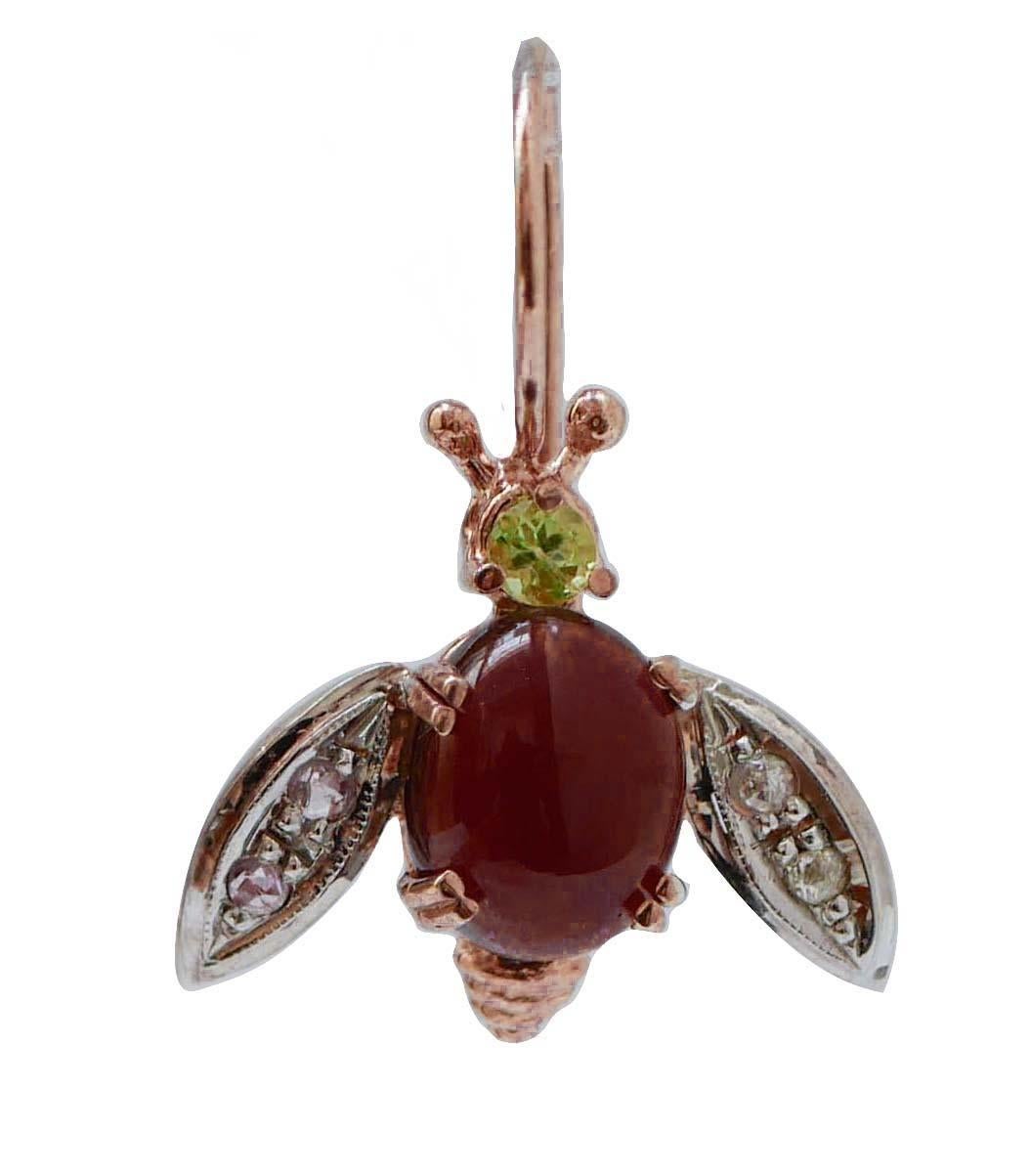 Particular fly shape earrings in 9kt rose gold and silver structure mounted with a peridot on the head; the body is mounted with a garnet and the wings are studded with diamonds.
These earrings are totally handmade by Italian master goldsmiths and