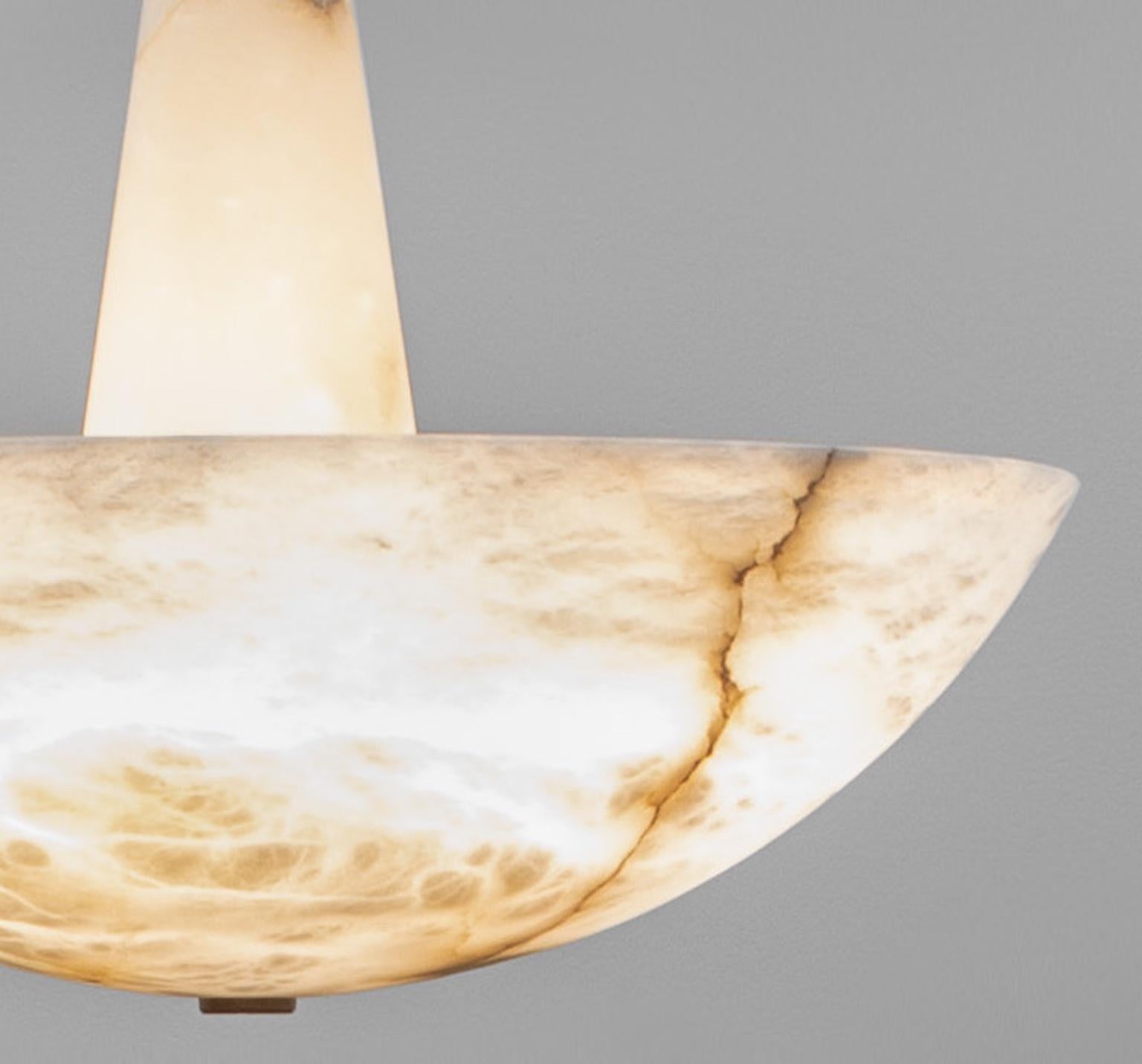 Pendant light by Garnier & Linker : Shade made out of veined Alabaster or Alabaster combined with dark natural brass patina. A 