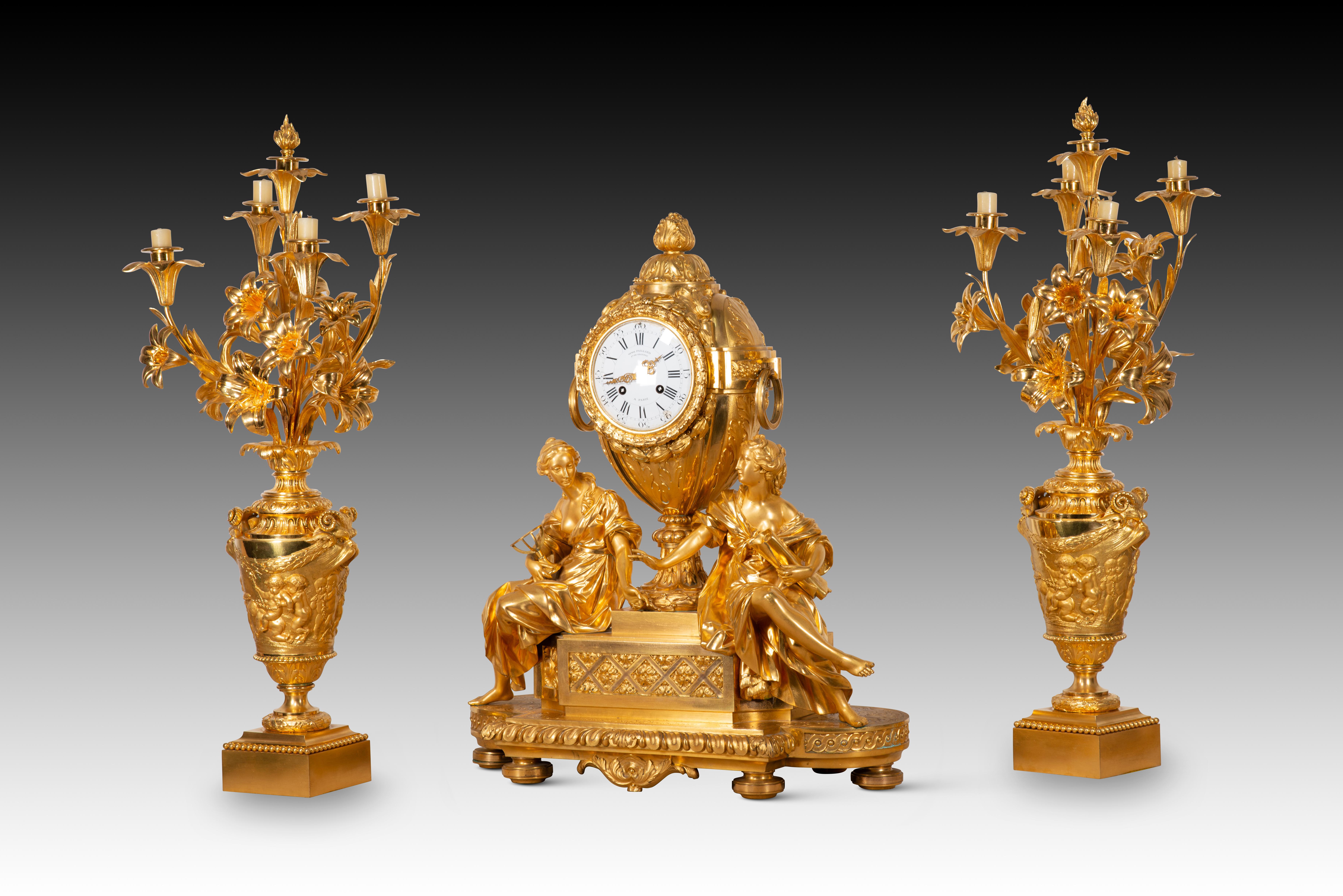 Garnish, clock and two candlesticks. Gilt bronze. Henri Picard and Victor Paillard. Paris, France, 1831-1864. 
 With markings (base, back). 
A gilded bronze clock with two four-light candelabras accompanied by flowers, with smooth bases and